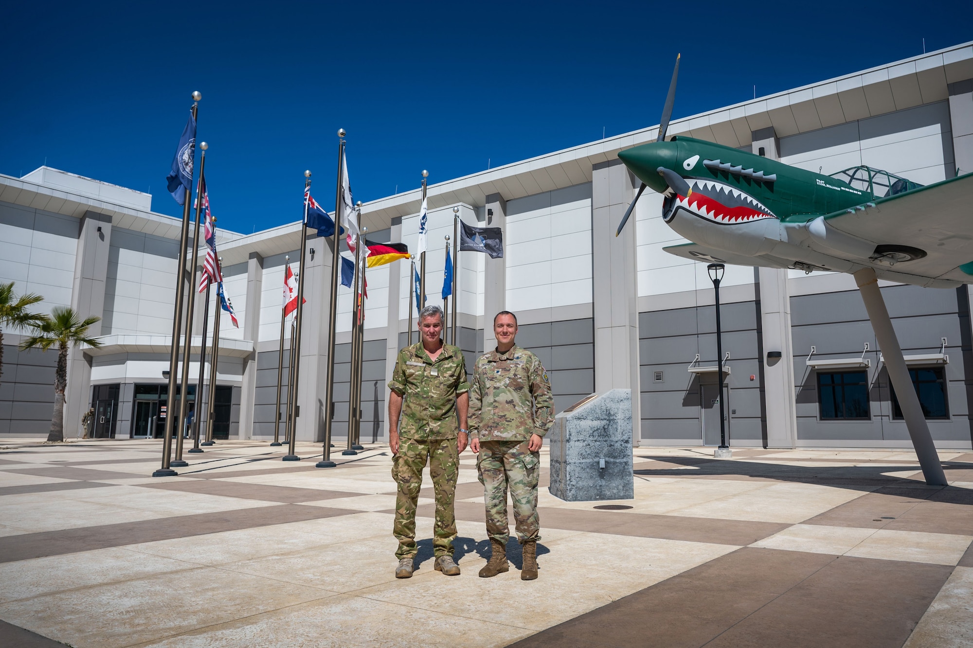 Royal New Zealand Air Force Air Commodore Shaun Sexton, Air Component Commander, left, and U.S. Space Force Lt. Col. Matthew Knepper, CJ5/8 Deputy Director, stand together outside of the Combined Force Space Component Command (CFSCC) headquarters at Vandenberg Space Force Base, Calif., April 21, 2023. As a part of the Combined Space Operations initiative, New Zealand is a key partner in encouraging the responsible and sustainable use of space. (U.S. Space Force photo by Tech. Sgt. Luke Kitterman)