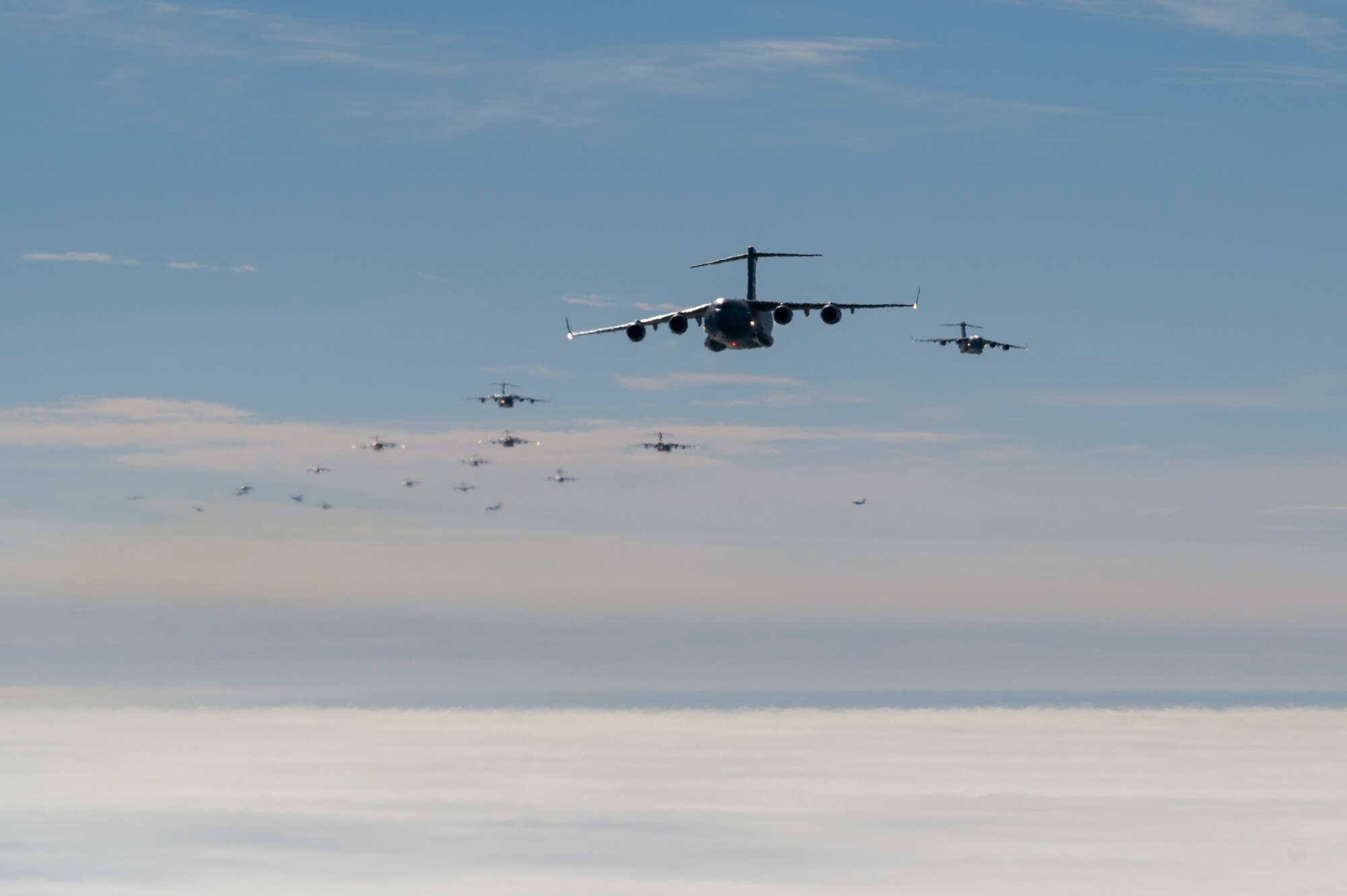 U.S. Air Force C-17 Globemaster IIIs assigned to the 437th Airlift Wing fly above Charleston, South Carolina, Jan. 5, 2023. This mission generation exercise kicks off Mobility Guardian 23 and involved the launch of 24 C-17s for the largest-ever show-of-force formation flight over Charleston Harbor. After the flyover, the formation dispersed to sharpen agile combat employment concepts that leverage rapid mobility to maximize lethality. (U.S. Air Force photo by Staff Sgt. Joseph Pick)