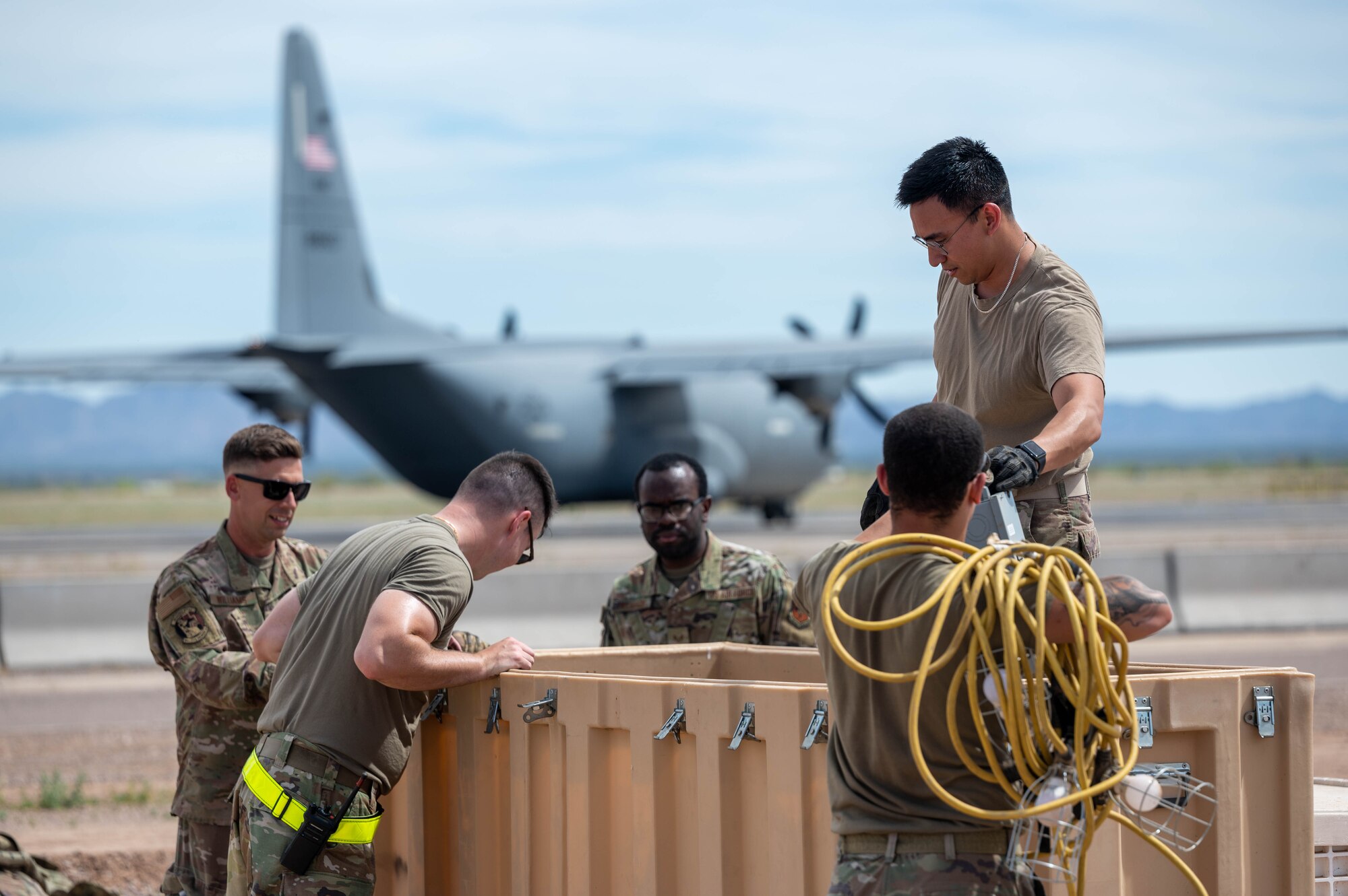 U.S. Air Force Airmen assigned to the 56th Fighter Wing unload cargo during exercise Wild Coyote, April 12, 2023 at Gila Bend Air Force Auxiliary Field, Arizona.