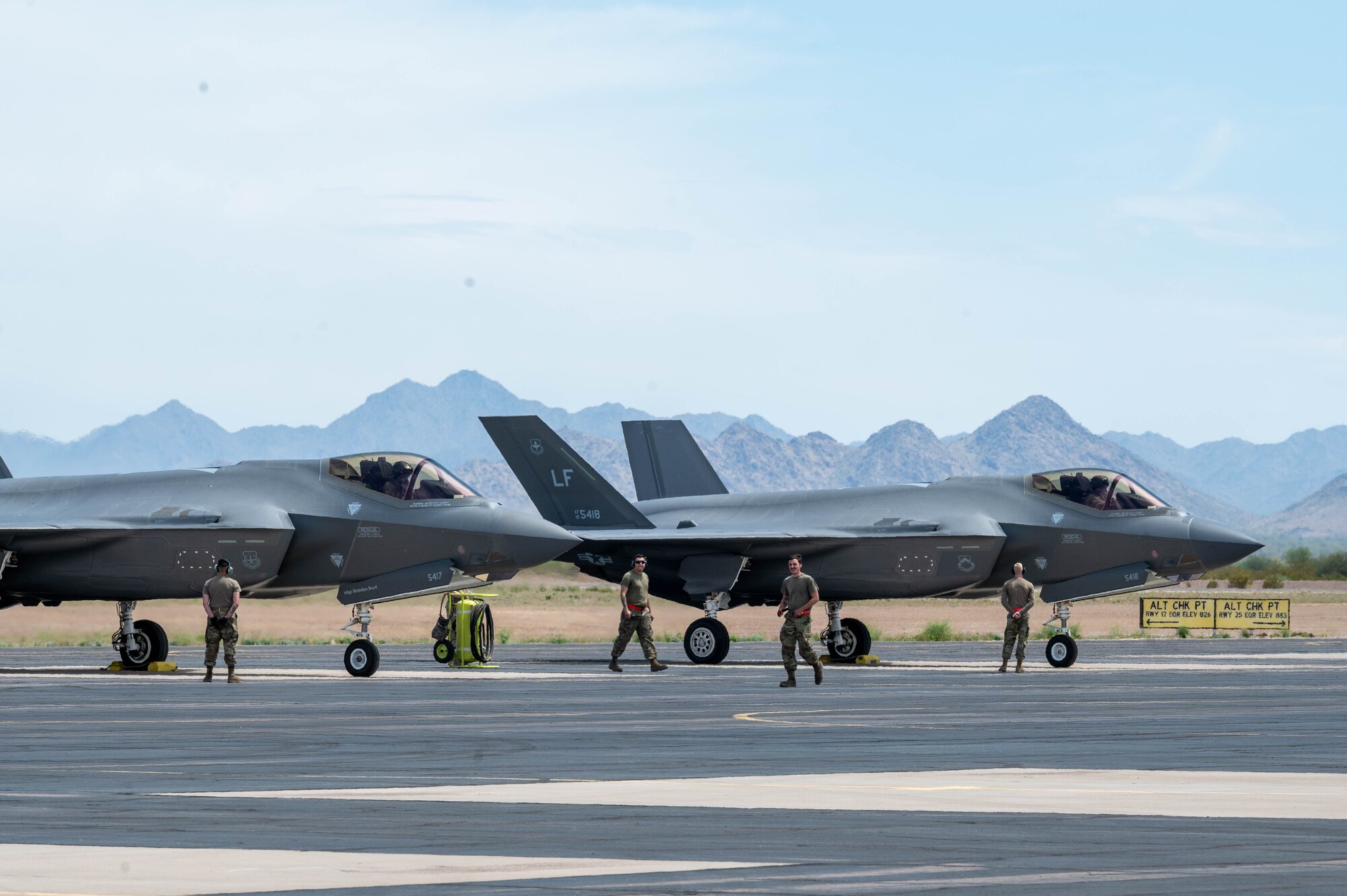 U.S. Air Force Airmen from the 56th Fighter Wing prepare to launch two F-35A Lightning II aircraft during exercise Wild Coyote, April 13, 2023, at Gila Bend Air Force Auxiliary Field, Arizona.