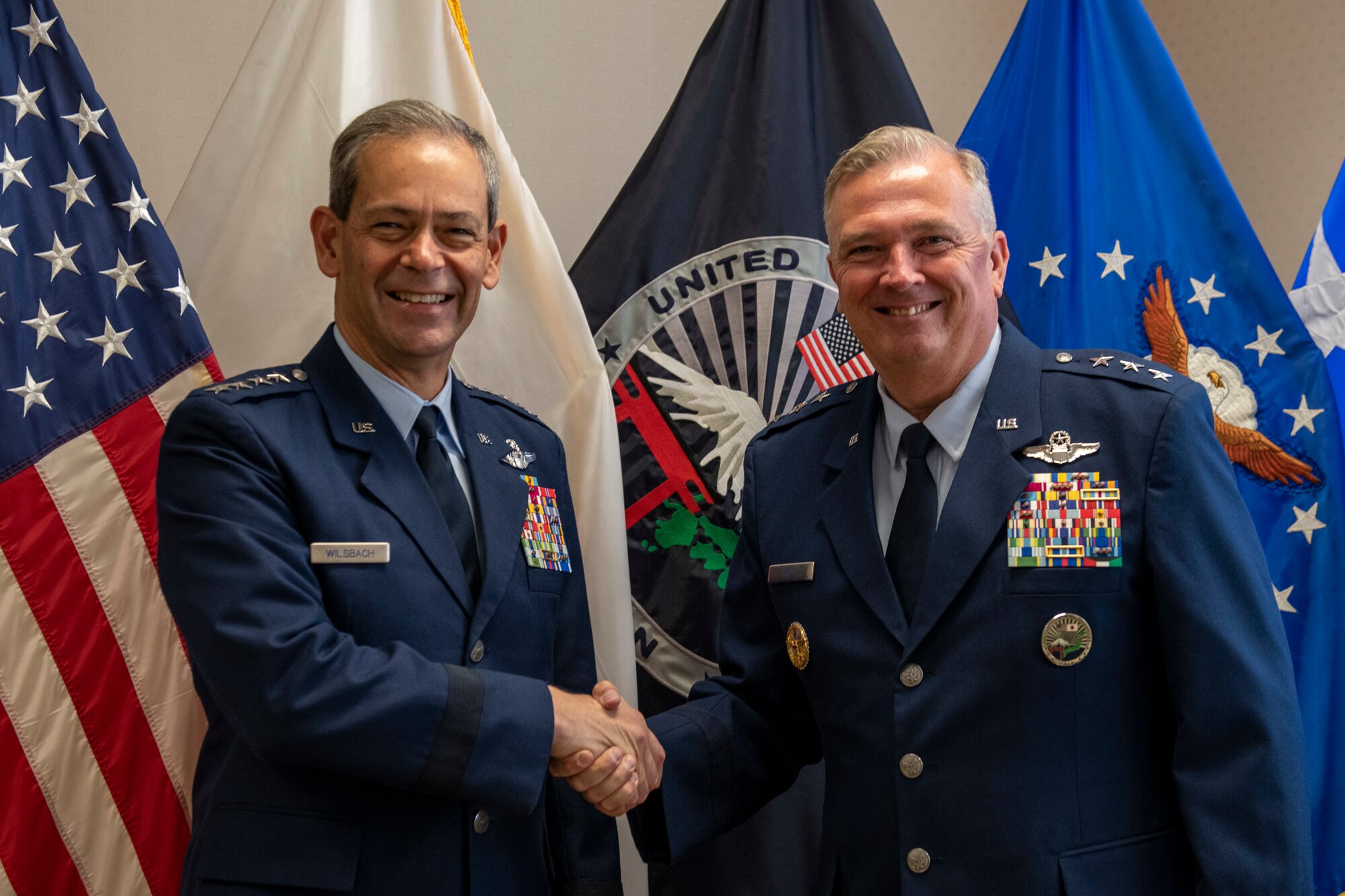 two generals in formal wear shake hands