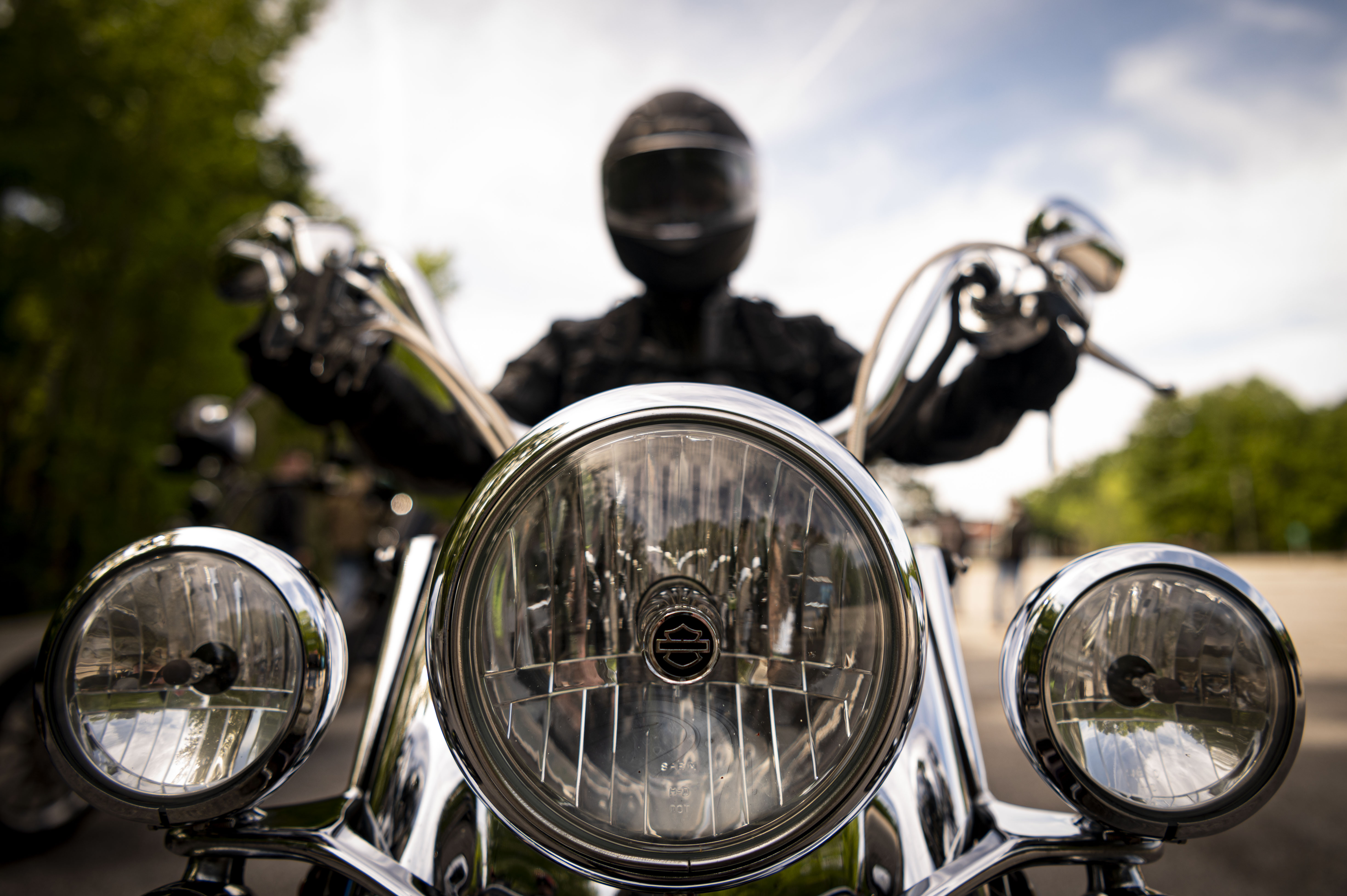 An individual sitting on a motorcycle poses for a photo.