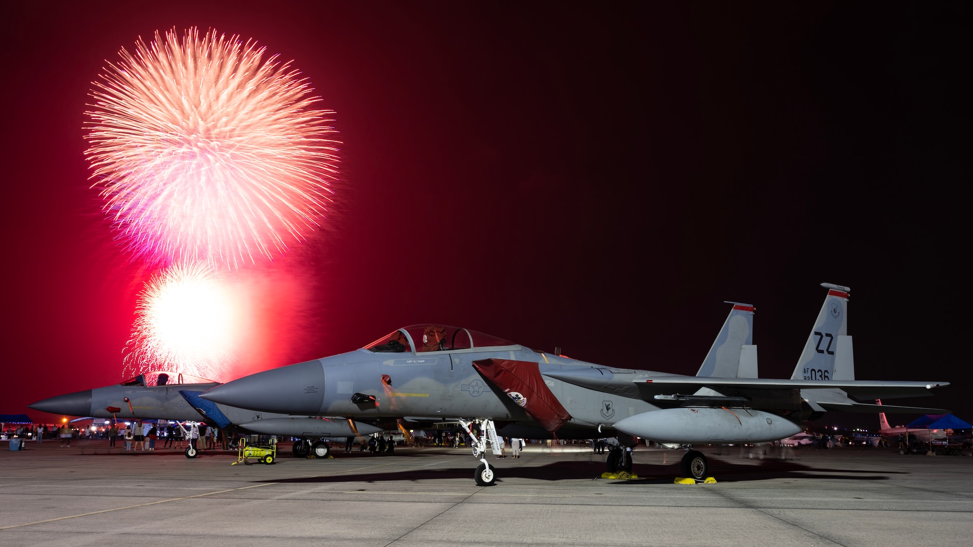 U.S. Air Force F-15C Eagles are on display as a fireworks presentation closes out day one of America Fest 2023 at Kadena Air Base, Japan, April 22, 2023. America Fest is Kadena Air Base’s open house event where attendees viewed static aircraft displays, interacted with U.S. service members and enjoyed a wide variety of entertainment and activities. (U.S. Air Force photo by Senior Airman Jessi Roth)