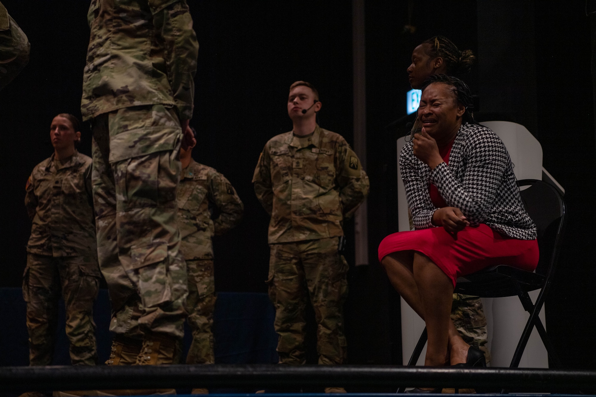 A cast member enacts a scene during the play, “The Introduction,” at Ramstein Air Base, Germany on April 20, 2023.