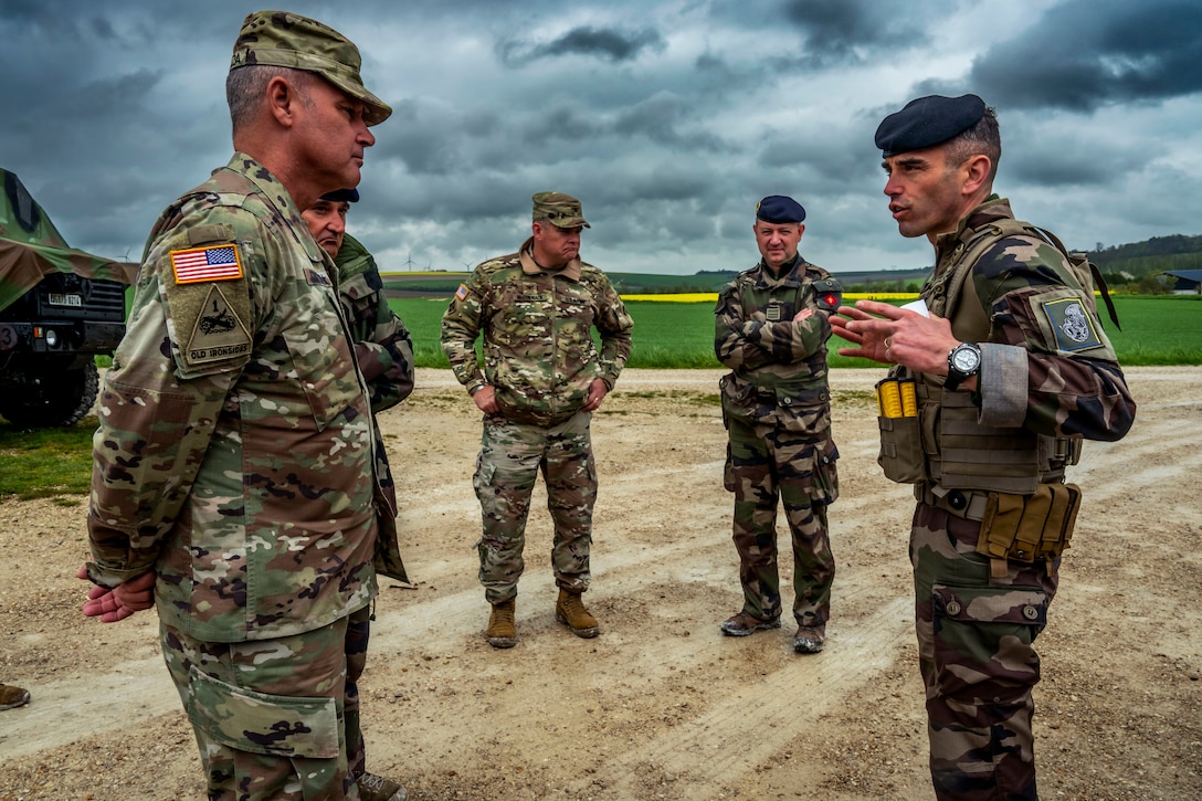 A senior U.S. officer speaks to a French senior officer.