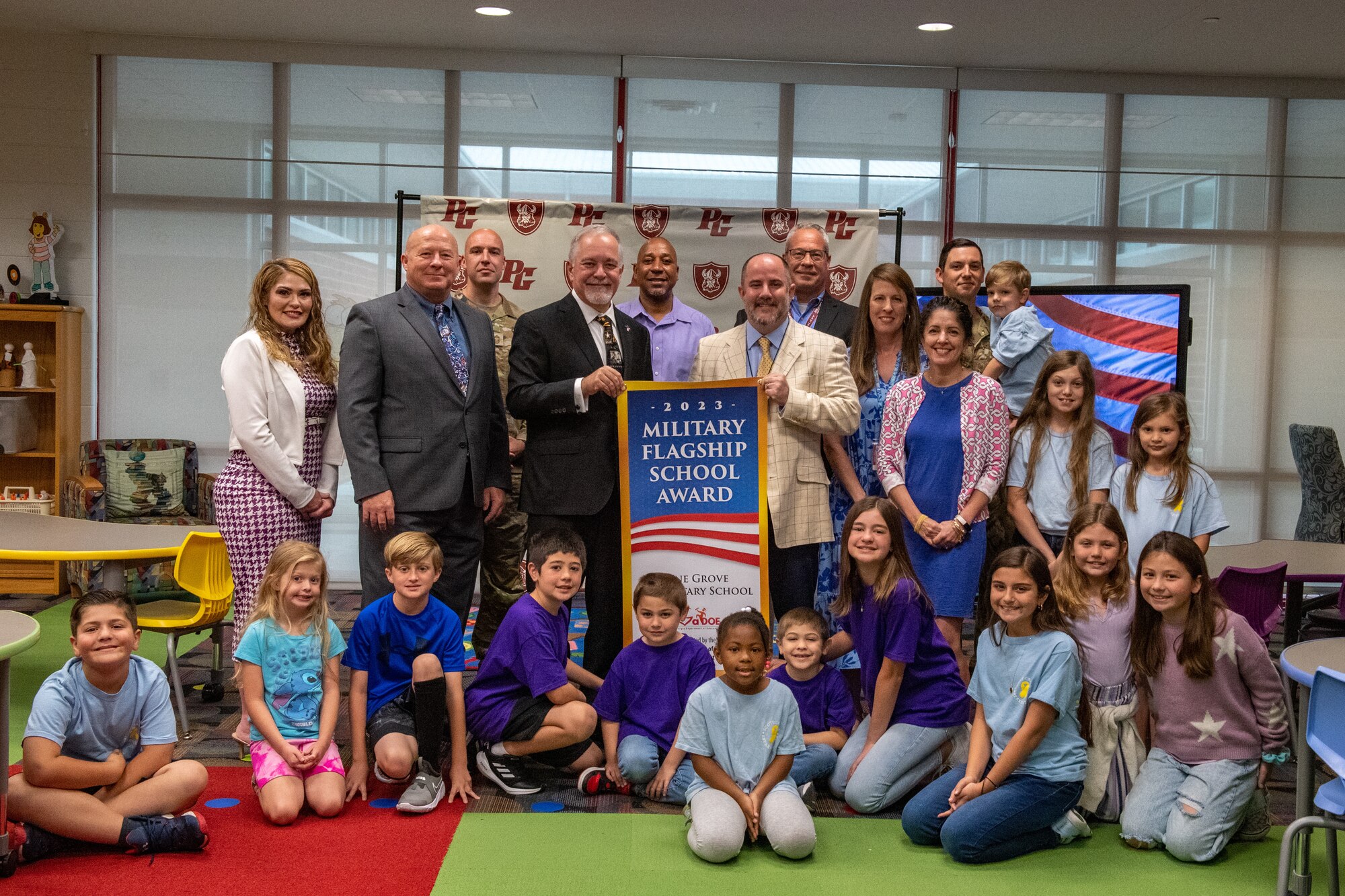 Representatives from Pine Grove Elementary School accept the Military Flagship School Award in Valdosta, Georgia, April 24, 2023. PGES was the first school in the district to receive a Military Family Life Counselor to help military children academically and emotionally while they attend school. (U.S. Air Force photo by Senior Airman Courtney Sebastianelli)