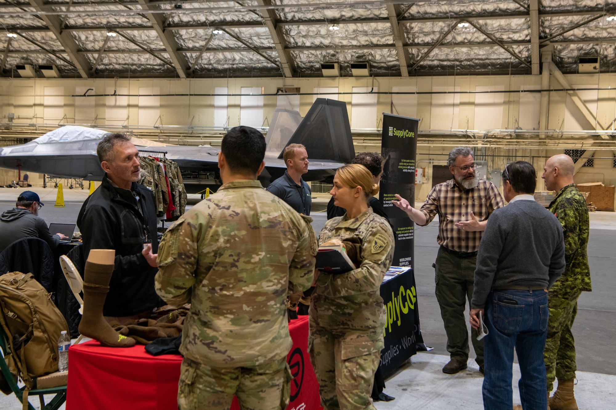 A photo of service members interacting with vendors at a technology expo