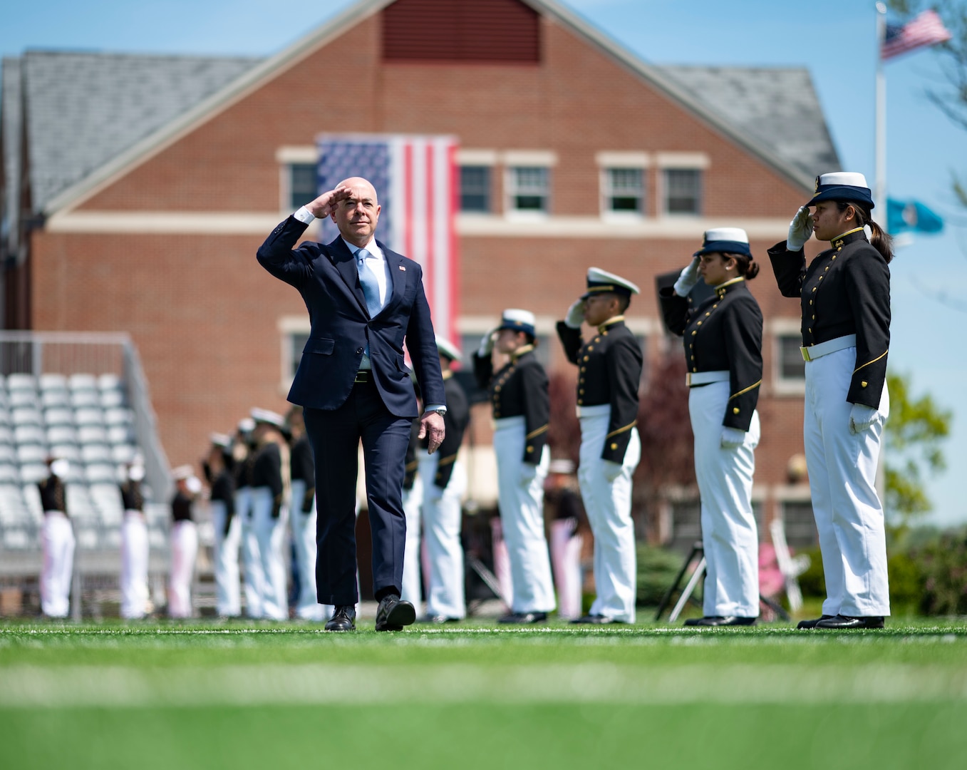 Alejandro Mayorkas, the Secretary of the Department of Homeland Security, walks toward a stage at the Coast Guard Academy