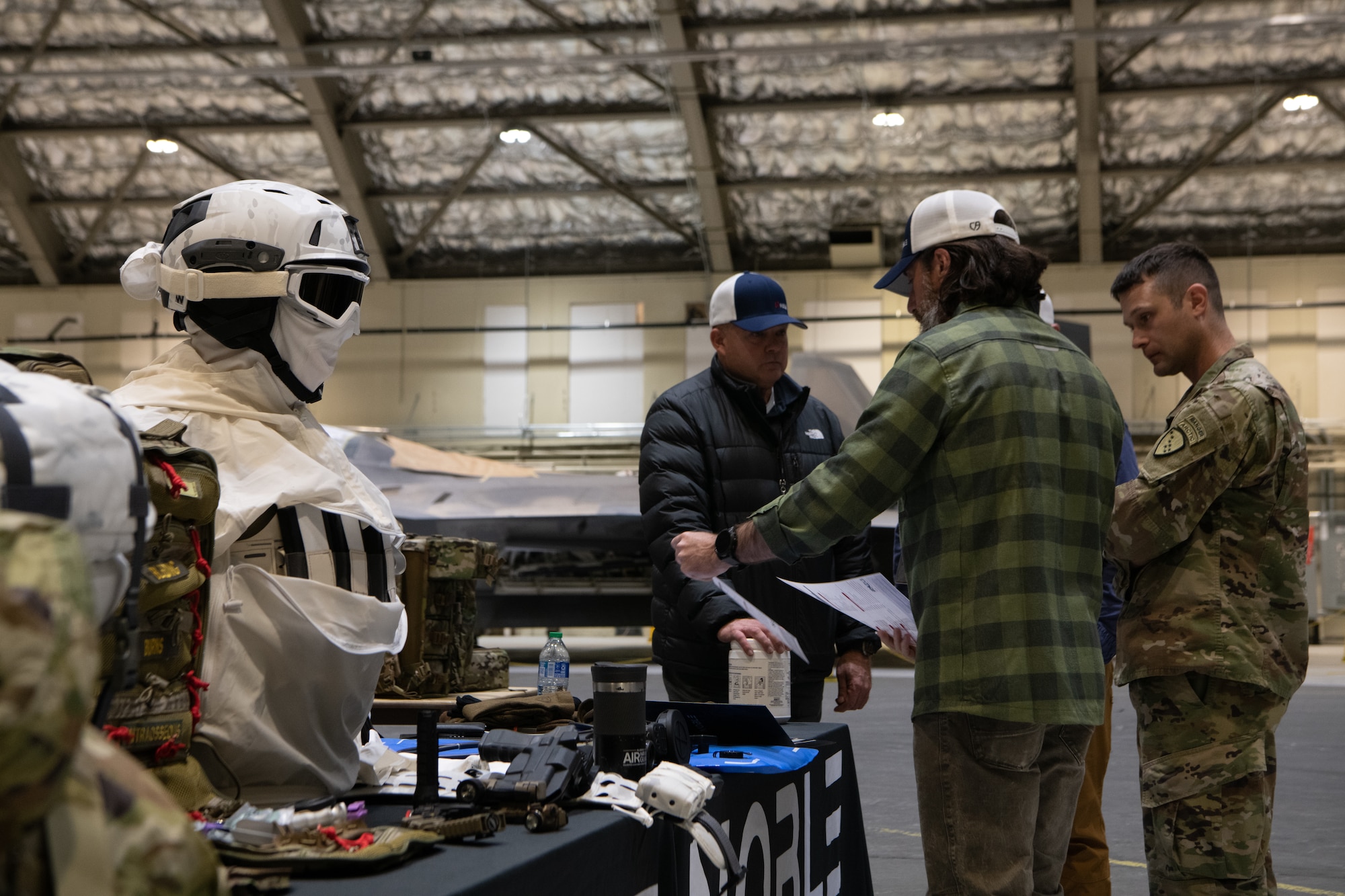 A photo of service members interacting with vendors at a technology expo