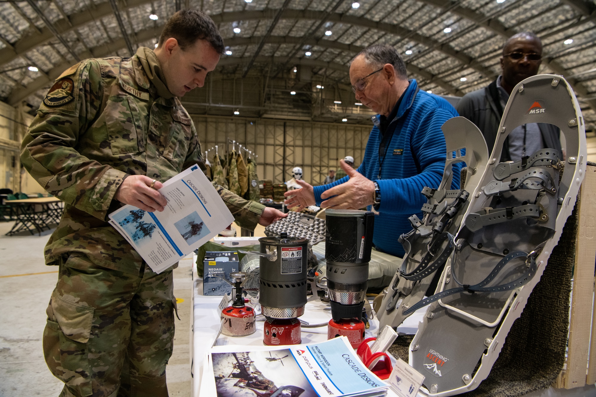 A photo of service members interacting with vendors at a technology expo