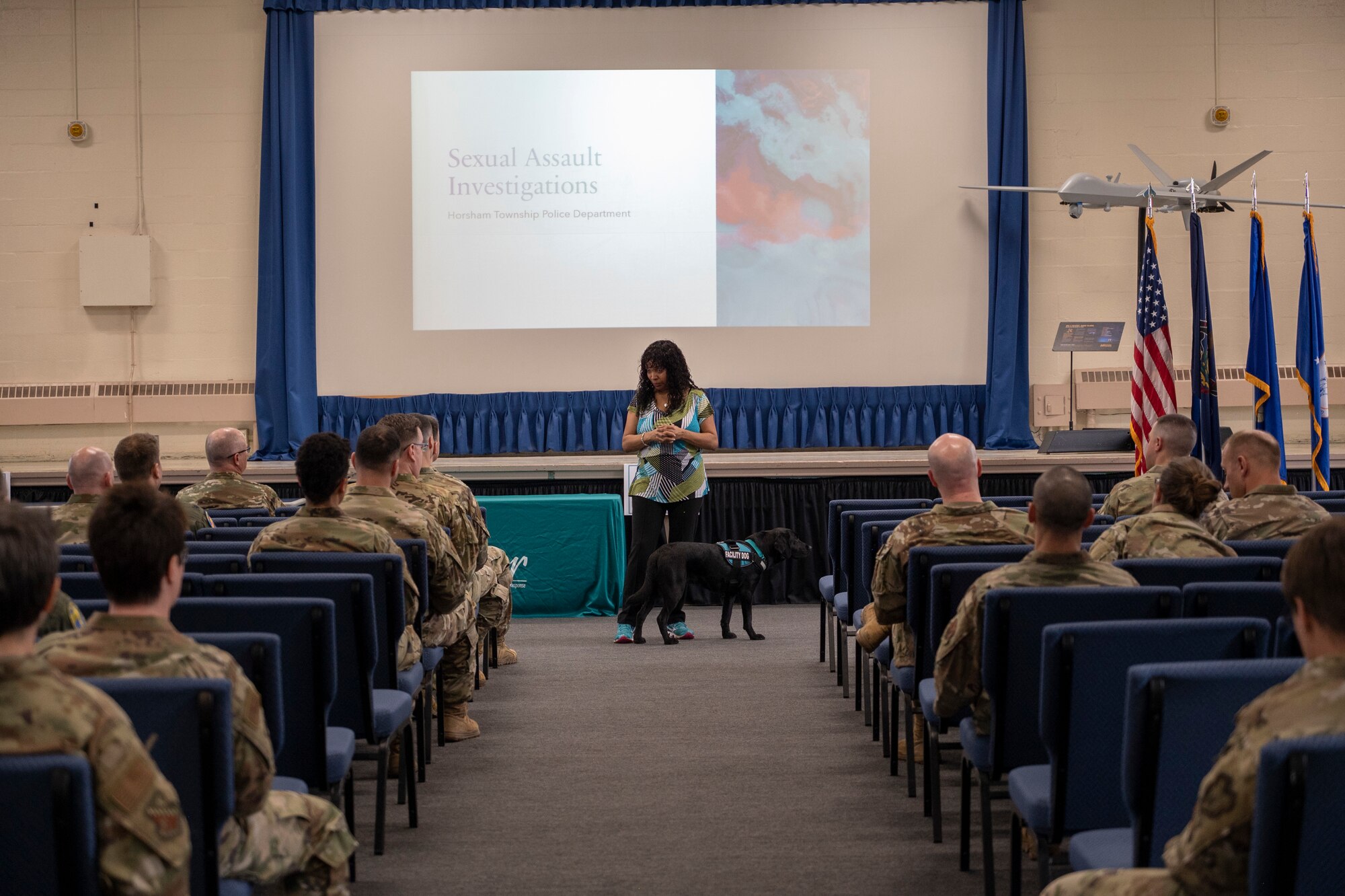A woman briefs a military audience.