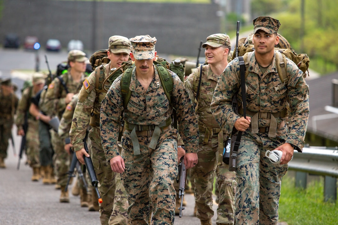 Marines and candidates with Officer Selection Team (OST) Roanoke ascend a hill during a formation hike as part of the Mini-Officer Candidate School (OCS) at Virginia Military Institute in Lexington, Virginia, April 22, 2023. Marines and candidates of OST Roanoke were exposed to operations orders, conditioning hike preparation, and land navigation to prepare for the rigors of OCS. (U.S. Marine Corps photo by Cpl. Bernadette Pacheco)