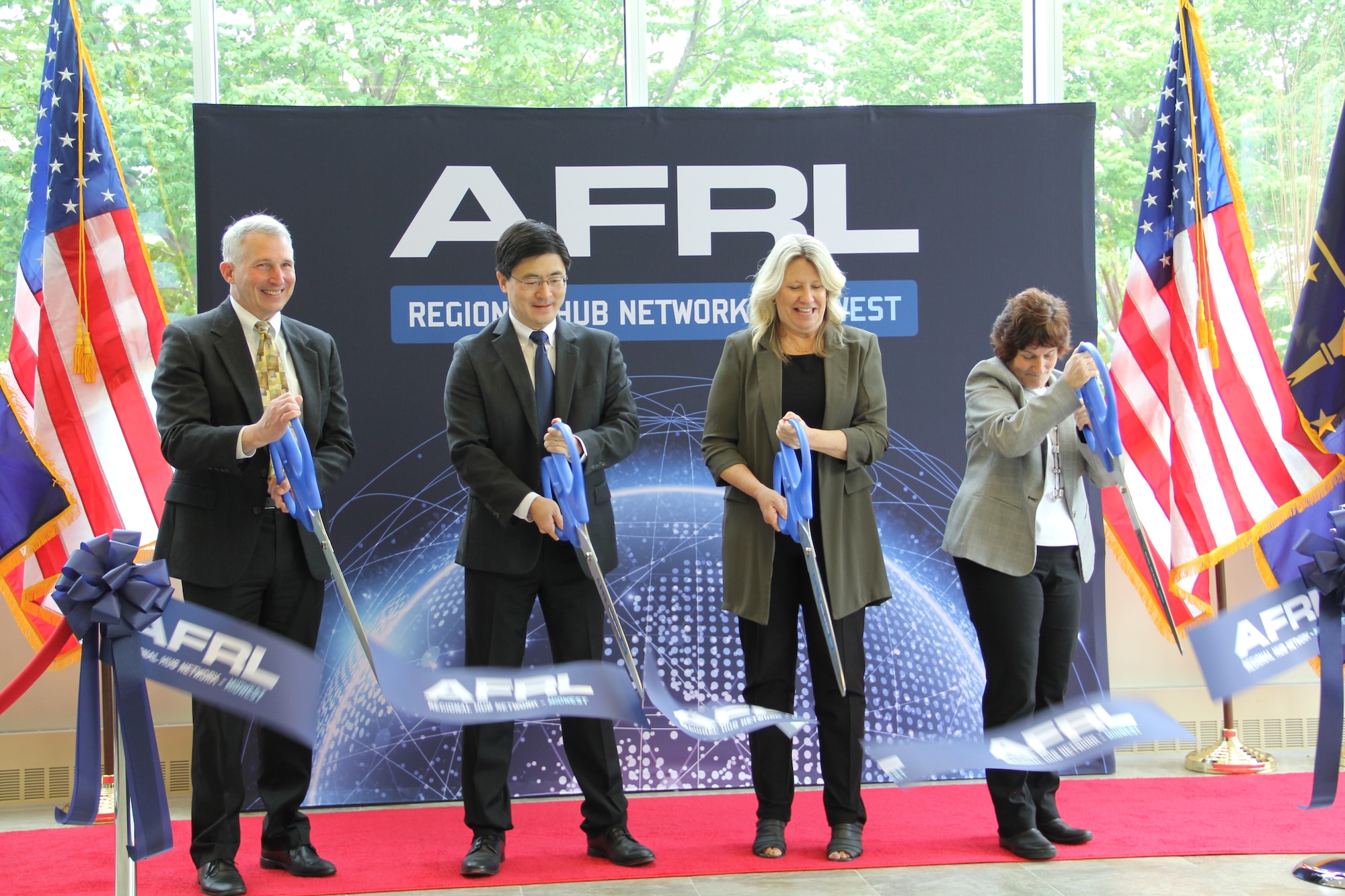 From left: Dr. Richard Vaia, chief scientist, Materials and Manufacturing Directorate at Air Force Research Laboratory, or AFRL; Mung Chiang, president, Purdue University; Monica Poelking, deputy chief technology officer at AFRL; and Dr. Karen Plaut, principal investigator, AFRL Regional Network Hub-Midwest, cut the ribbon during an opening ceremony for the partnership between AFRL and Purdue University to kick off the Regional Hub Network - Midwest April 21, 2023, at Purdue University in West Lafayette, Indiana. (U.S. Air Force photo / Aleah M. Castrejon)