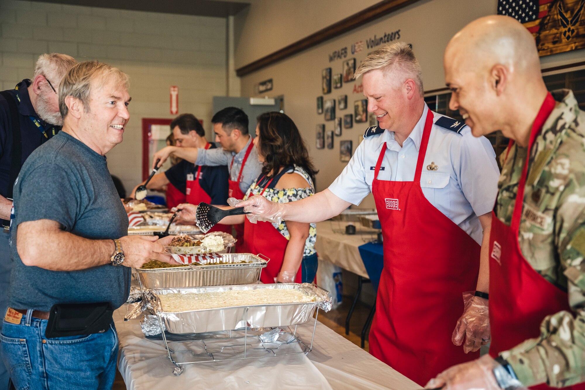 Col. Charles Barkhurst, 88th Air Base Wing vice commander, and Chief Master Sgt. Lloyd Morales, 88th Air Base Wing command chief, serve volunteers during the annual USO volunteer appreciation dinner at Wright-Patterson Air Force Base, Ohio, April 20.