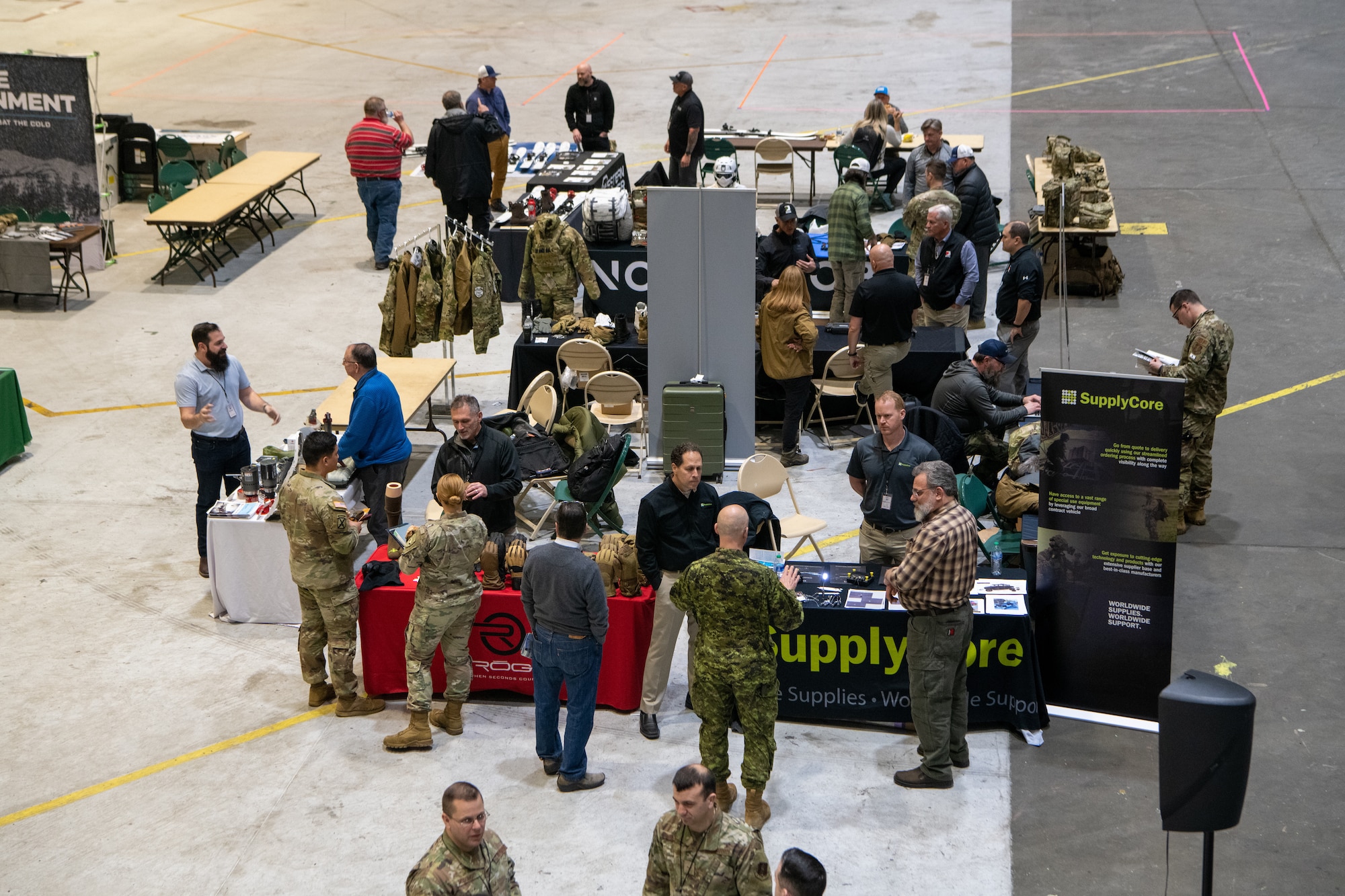A photo of service members interacting with vendors at a technology expo