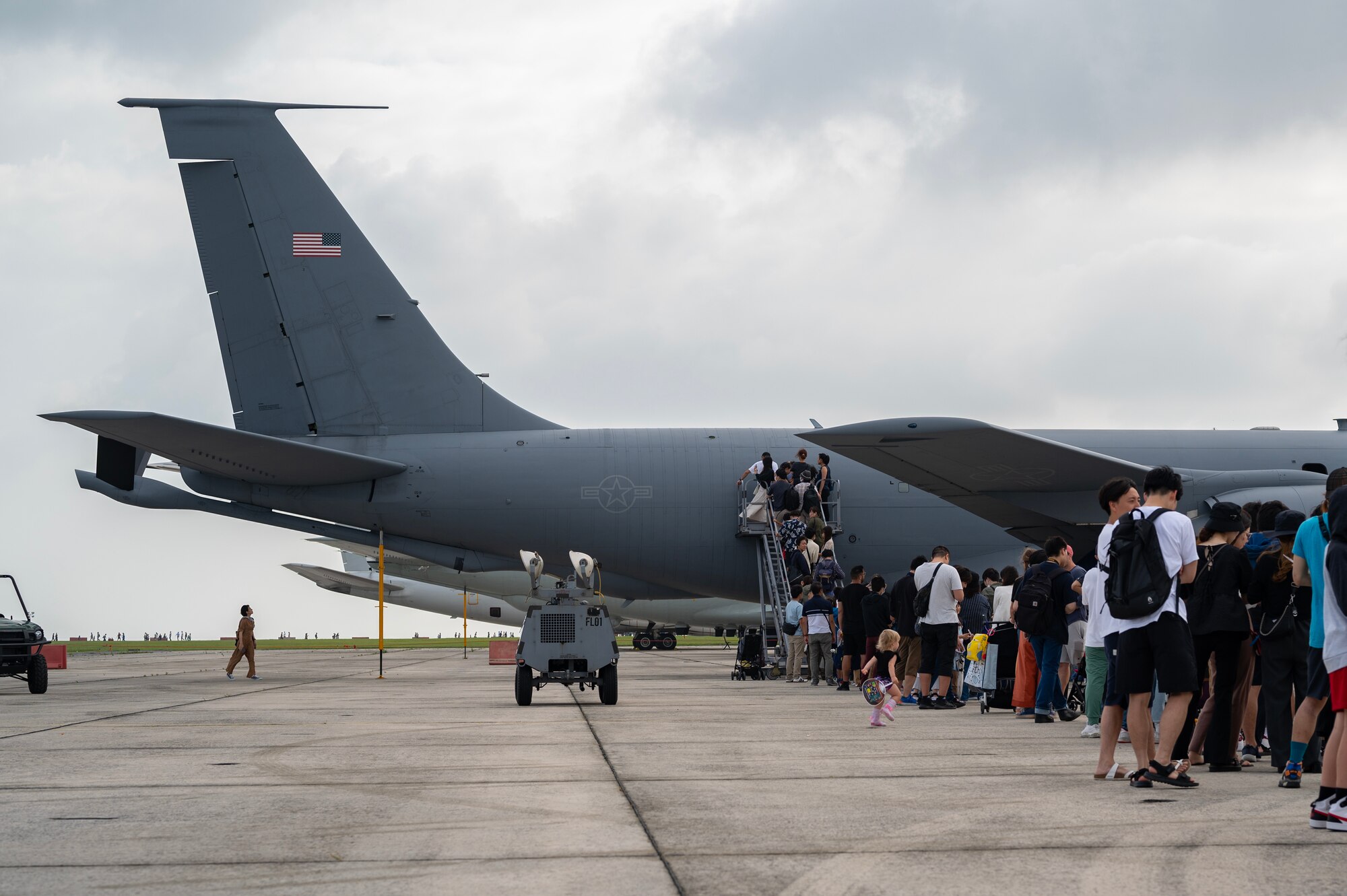 Festival attendees line up to tour a U.S. Air Force KC-135 Stratotanker static display during America Fest 2023 at Kadena Air Base, Japan, April 22, 2023. The two-day event was open to the public and enabled attendees to learn about the U.S. military’s role in keeping the Indo-Pacific region free and open. (U.S. Air Force photo by Senior Airman Jessi Roth)
