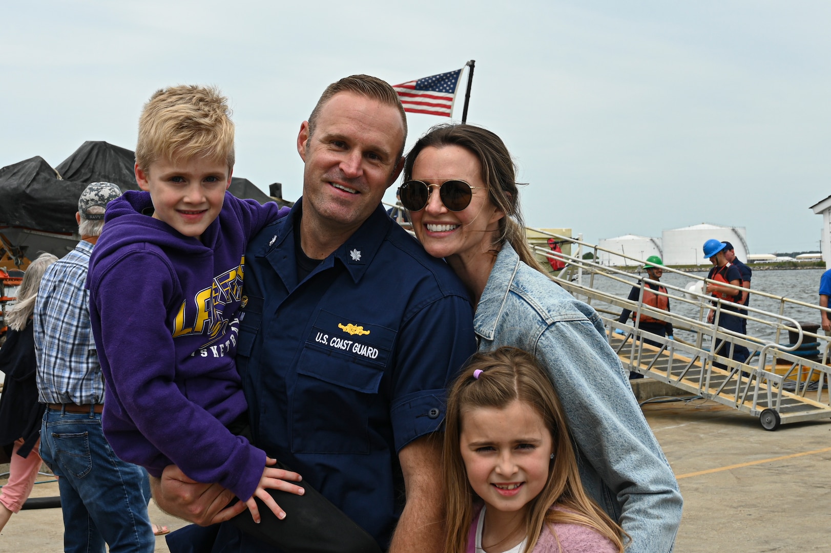 U.S. Coast Guard Cmdr. Sky Holm, the commanding officer of USCGC Tampa (WMEC 902), poses for a photo with his family at the cutter's return to home port in Portsmouth, Virginia, April 26, 2023. Tampa returned home following an 88-day patrol in the Florida Straits and Caribbean Sea. (U.S. Coast Guard photo by Petty Officer 3rd Class Kate Kilroy)