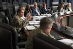 A group of people sit at a round table