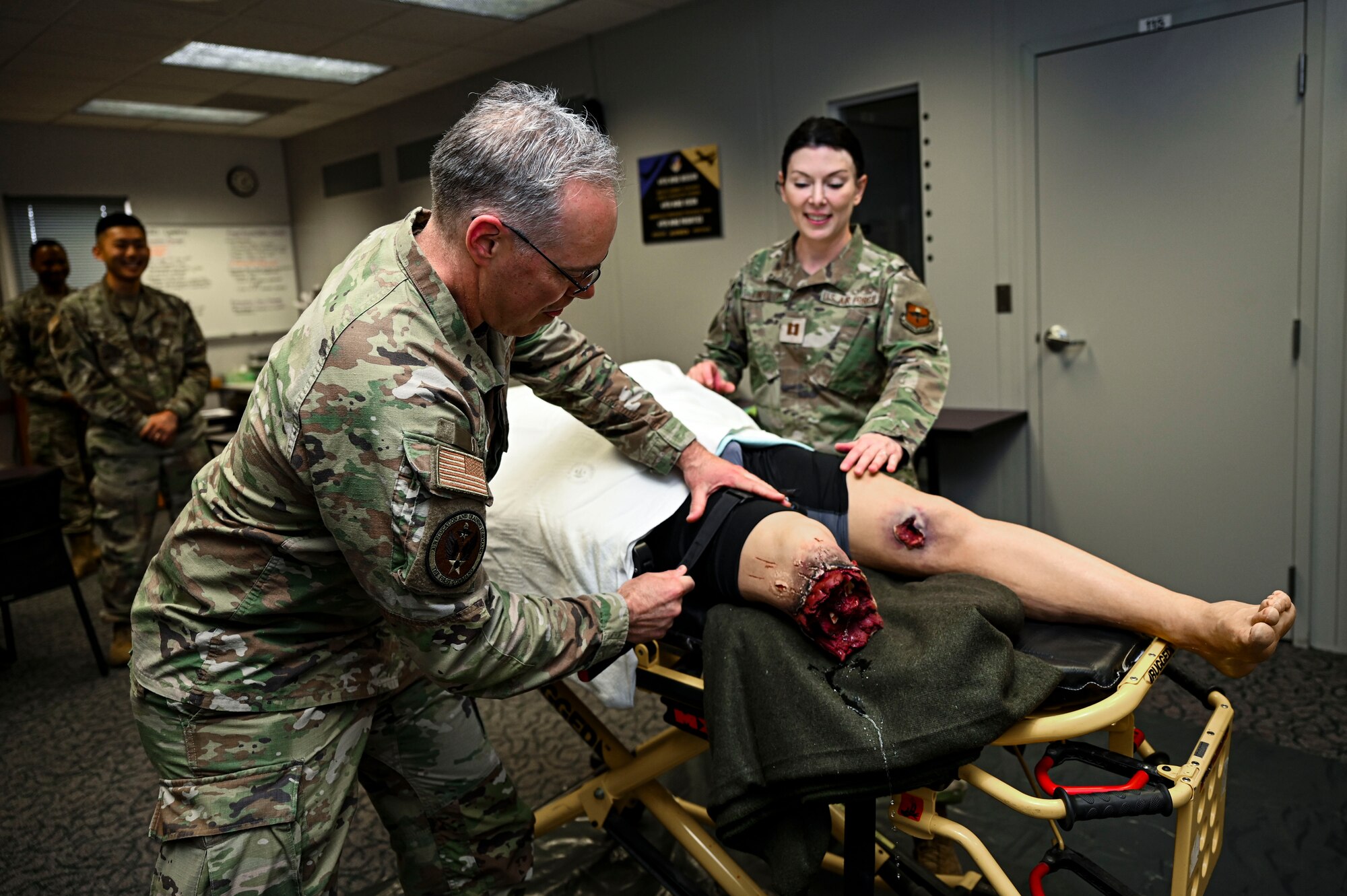 U.S. Air Force Col. Christopher Grussendorf, Air Education and Training Command surgeon general, performs Tactical Combat Casualty Care on a test dummy at Holloman Air Force Base, New Mexico, April 13, 2023. TCCC is utilized to teach both service members and civilians life-saving techniques that can help save lives on the battlefield and in other life-threatening scenarios. (U.S. Air Force photo by Airman 1st Class Isaiah Pedrazzini)