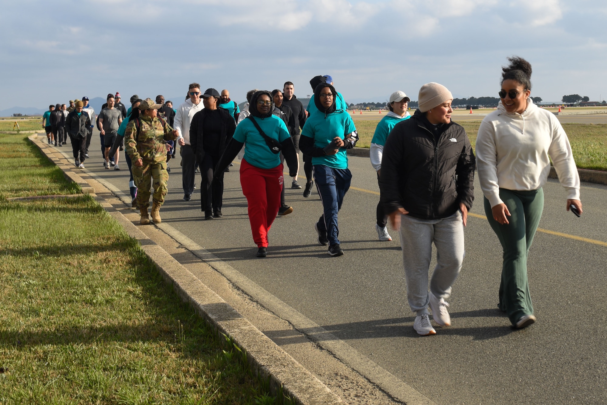 Members of the Wolf Pack walk together during a vigil walk for Sexual Assault Awareness and Prevention Month and National Child Abuse Prevention Month at Kunsan Air Base, Republic of Korea, April 26, 2023. Participants were encouraged to talk with one another to help foster conversation about issues such as sexual assault awareness and child abuse and how to recognize and prevent it.  (U.S. Air Force photo by Tech. Sgt. Timothy Dischinat)