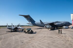 A U.S. Air Force F-15E Strike Eagle aircraft is connected to a C-17 Globemaster III aircraft for aircraft-to-aircraft refueling operations, one of the many agile combat employment strategies being tested at Exercise Southern Strike at Gulfport Combat Readiness Training Center, Gulfport, Mississippi, April 20, 2023. The large-scale, joint and international combat exercise features agile combat employment, counterinsurgency, close air support, non-combatant evacuations, and maritime special operations.