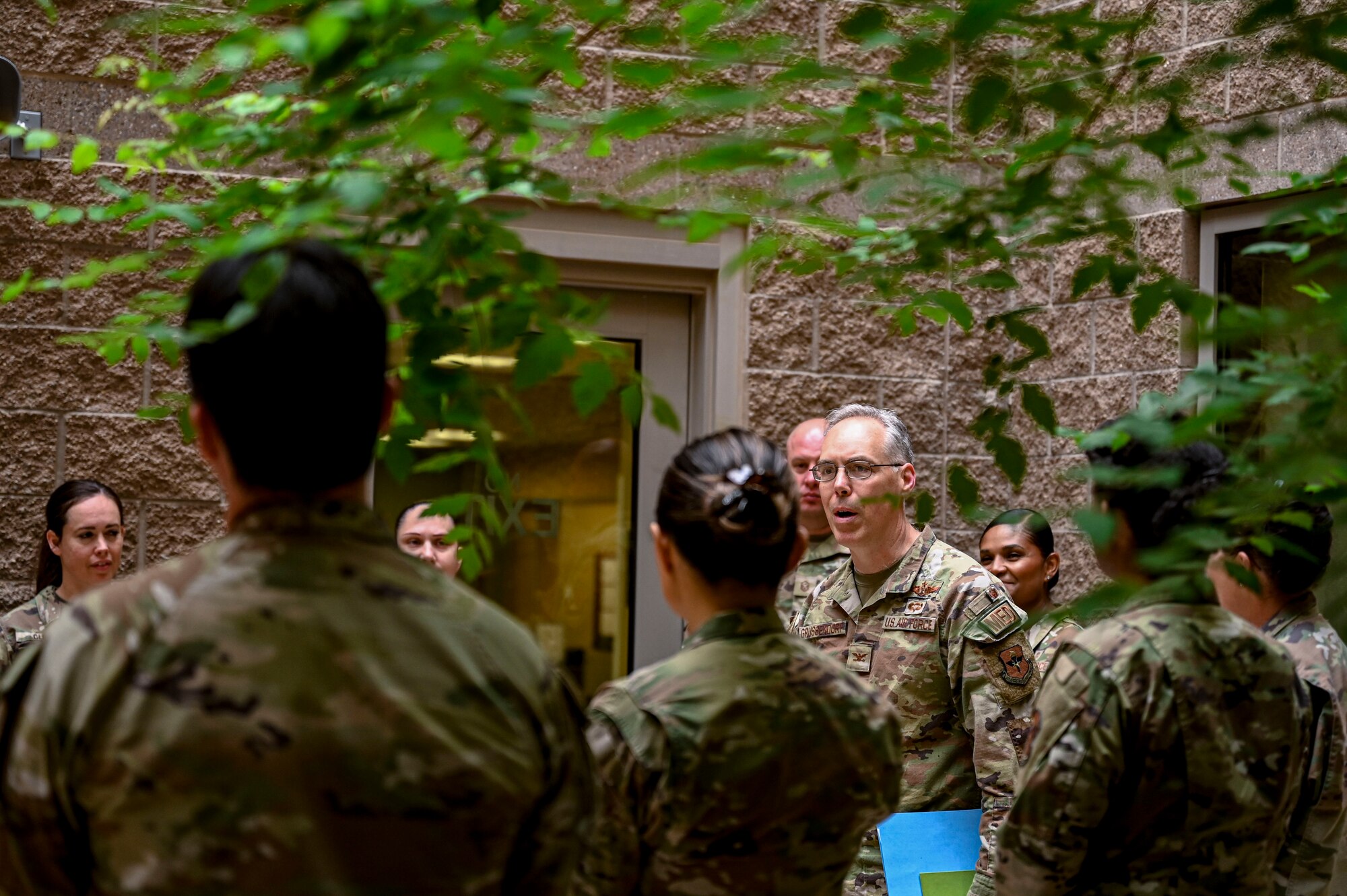 U.S. Air Force Col. Christopher Grussendorf, Air Education and Training Command surgeon general, converses with 49th Medical Group staff at Holloman Air Force Base, New Mexico, April 13, 2023. The 49th MDG’s primary mission is to sustain and enhance a culture of safety, maximize combat readiness, enhance access to quality patient care, and develop Airmen and staff. (U.S. Air Force photo by Airman 1st Class Isaiah Pedrazzini)