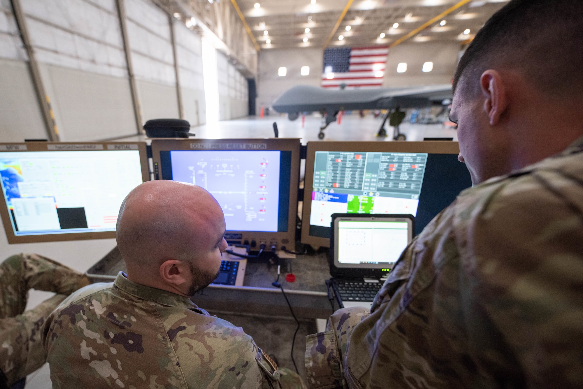 U.S. Air Force Staff Sgt. Tyler, left, and Staff Sgt. Cameron, 432nd Maintenance Squadron/Maintenance Operations Training Flight MQ-9 instructors, attend a portable aircraft control station (PACS) training course in support of the new satellite communications (SATCOM) satellite launch and recovery (SLR) and automatic takeoff and landing capability (ATLC) at Creech Air Force Base, Nevada, March 28, 2023. PACS allows maintenance Airmen to start MQ-9 reapers and transfer control to ATLC for launch. (U.S. Air Force photo by Senior Airman Kristal Munguia)