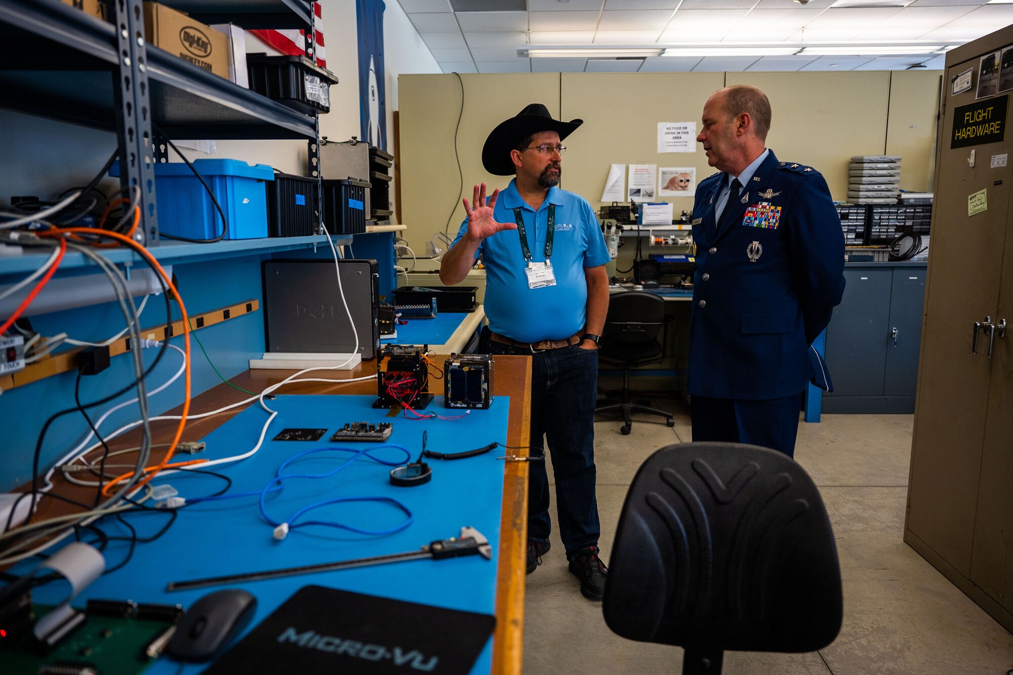 Dr. John Bellardo, Cal Poly CubeSat Laboratory Director, left, explains current student-developed satellite projects to U.S. Space Force Maj. Gen. Douglas A. Schiess, Combined Force Space Component Command commander, at California Polytechnic State University in San Luis Obispo, Calif., April 25, 2023. The Cal Poly CubeSat Laboratory is part of PolySat, a student-run, multidisciplinary independent research lab at the university which partnered with Vandenberg through a Cooperative Research and Development Agreement (CRADA) in 2019, the first of its kind between the base and an academic institution. A CRADA is a no-cost collaboration that enables the transfer and exchange of technology and professional expertise. (U.S. Space Force photo by Tech. Sgt. Luke Kitterman)