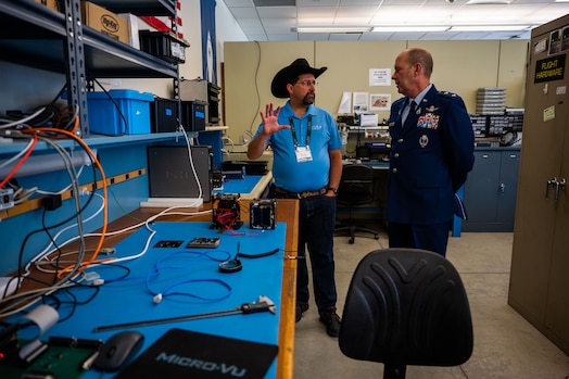  Dr. John Bellardo, Cal Poly CubeSat Laboratory Director, left, explains current student-developed satellite projects to U.S. Space Force Maj. Gen. Douglas A. Schiess, Combined Force Space Component Command commander, at California Polytechnic State University in San Luis Obispo, Calif., April 25, 2023. The Cal Poly CubeSat Laboratory is part of PolySat, a student-run, multidisciplinary independent research lab at the university which partnered with Vandenberg through a Cooperative Research and Development Agreement (CRADA) in 2019, the first of its kind between the base and an academic institution. A CRADA is a no-cost collaboration that enables the transfer and exchange of technology and professional expertise. (U.S. Space Force photo by Tech. Sgt. Luke Kitterman)