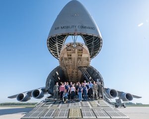 Dover Air Force Base honorary commanders pose for a group photo in front of a C-5M Super Galaxy at Dover AFB, Delaware, April 21, 2023. The honorary commanders toured various elements of the 436th Operations Group to familiarize them with the group's mission and airlift capabilities. (U.S. Air Force photo by Mauricio Campino)