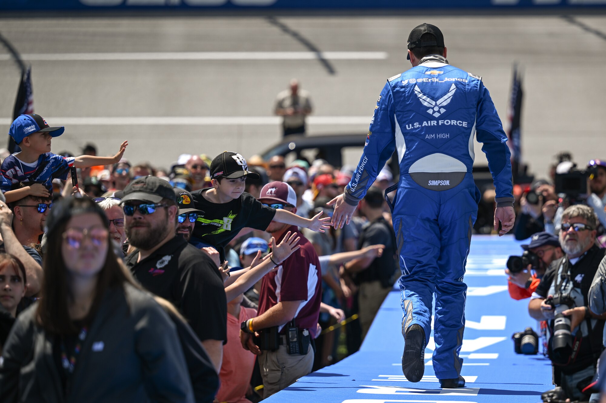 Erik Jones, driver of the #43 Air Force-themed car walks down the stage at Talladega Superspeedway.