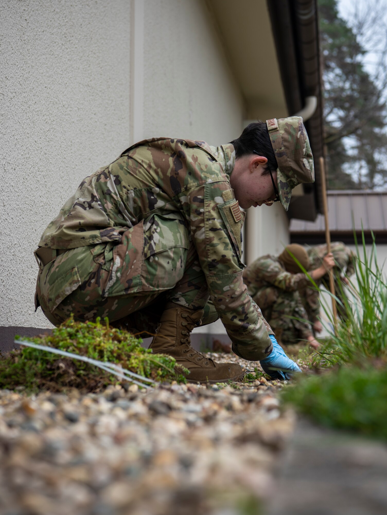 U.S. Air Force Airman 1st Class Raeanna Cunningham, 86th Maintenance Squadron precision measurement equipment laboratory apprentice, pulls weeds during Installation Excellence Day at Ramstein Air Base, Germany, April 18, 2023.