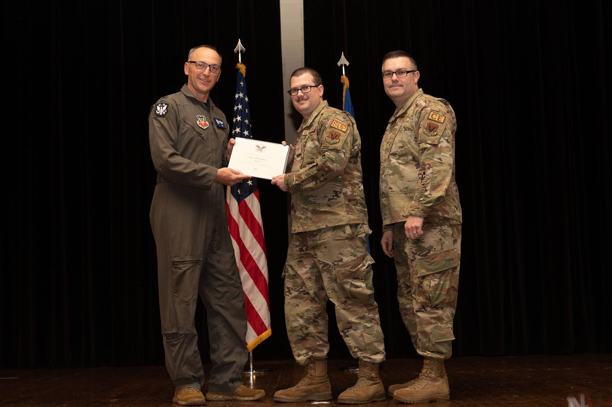 Col. Steven Bofferding, left, 4th Fighter Wing vice commander, and Chief Master Sgt. Kyle O’Hara, right, 4th Civil Engineer Squadron command chief, present the Bronze Presidential Volunteer Service Award to a Seymour Johnson Air Force Base volunteer during a volunteer appreciation ceremony at Seymour Johnson Air Force Base, North Carolina, April 21, 2023. The Bronze award winners have completed 100 to 174 hours for young adults, 100 to 249 hours for adults and 200 to 499 for families and groups. (U.S. Air Force photo by Airman 1st Class Rebecca Sirimarco-Lang)