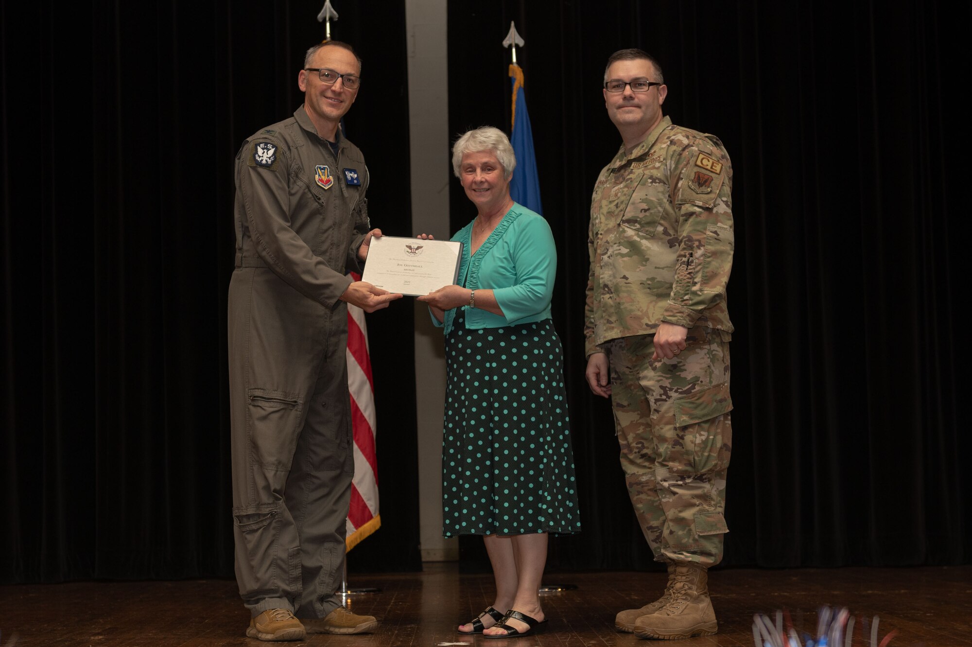 Col. Steven Bofferding, left, 4th Fighter Wing vice commander, and Chief Master Sgt. Kyle O’Hara, right, 4th Civil Engineer Squadron command chief, present the Bronze Presidential Volunteer Service Award to a Seymour Johnson Air Force Base volunteer during a volunteer appreciation ceremony at Seymour Johnson Air Force Base, North Carolina, April 21, 2023. The Bronze award winners have completed 100 to 174 hours for young adults, 100 to 249 hours for adults and 200 to 499 for families and groups. (U.S. Air Force photo by Airman 1st Class Rebecca Sirimarco-Lang)