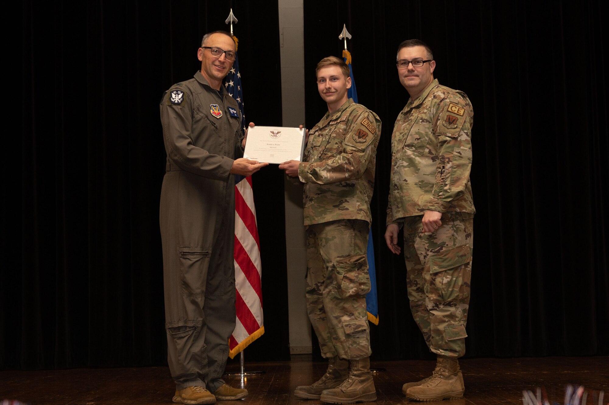 Col. Steven Bofferding, left, 4th Fighter Wing vice commander, and Chief Master Sgt. Kyle O’Hara, right, 4th Civil Engineer Squadron command chief, present the Bronze Presidential Volunteer Service Award to a Seymour Johnson Air Force Base volunteer during a volunteer appreciation ceremony at Seymour Johnson Air Force Base, North Carolina, April 21, 2023. The Bronze award winners have completed 100 to 174 hours for young adults, 100 to 249 hours for adults and 200 to 499 for families and groups. (U.S. Air Force photo by Airman 1st Class Rebecca Sirimarco-Lang)