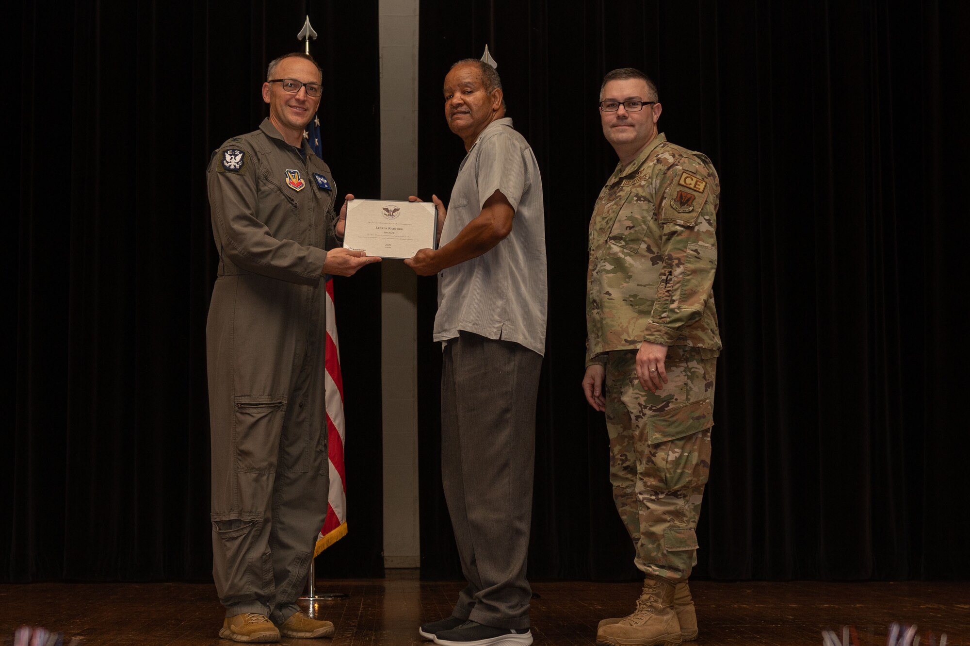 Col. Steven Bofferding, left, 4th Fighter Wing vice commander, and Chief Master Sgt. Kyle O’Hara, right, 4th Civil Engineer Squadron command chief, present the Bronze Presidential Volunteer Service Award to a Seymour Johnson Air Force Base volunteer during a volunteer appreciation ceremony at Seymour Johnson Air Force Base, North Carolina, April 21, 2023. The Bronze award winners have completed 100 to 174 hours for young adults, 100 to 249 hours for adults and 200 to 499 for families and groups. (U.S. Air Force photo by Airman 1st Class Rebecca Sirimarco-Lang)
