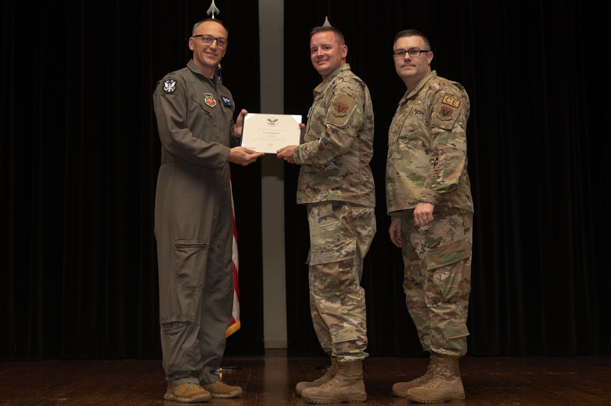 Col. Steven Bofferding, left, 4th Fighter Wing vice commander, and Chief Master Sgt. Kyle O’Hara, right, 4th Civil Engineer Squadron command chief, present the Sliver Presidential Volunteer Service Award to a Seymour Johnson Air Force Base volunteer during a volunteer appreciation ceremony at Seymour Johnson Air Force Base, North Carolina, April 21, 2023. The Sliver award winners have completed 175 to 249 hours for young adults, 250 to 499 hours for adults and 500 to 999 for families and groups. (U.S. Air Force photo by Airman 1st Class Rebecca Sirimarco-Lang)