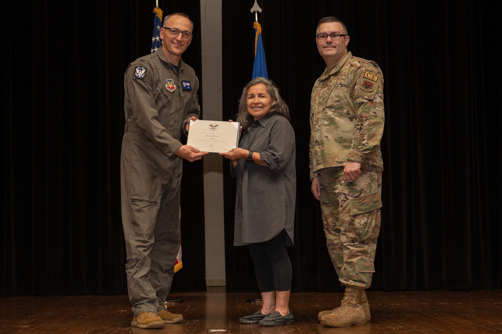 Col. Steven Bofferding, left, 4th Fighter Wing vice commander, and Chief Master Sgt. Kyle O’Hara, right, 4th Civil Engineer Squadron command chief, present the Bronze Presidential Volunteer Service Award to a Seymour Johnson Air Force Base volunteer during a volunteer appreciation ceremony at Seymour Johnson Air Force Base, North Carolina, April 21, 2023. The Bronze award winners have completed 100 to 174 hours for young adults, 100 to 249 hours for adults and 200 to 499 for families and groups. (U.S. Air Force photo by Airman 1st Class Rebecca Sirimarco-Lang)