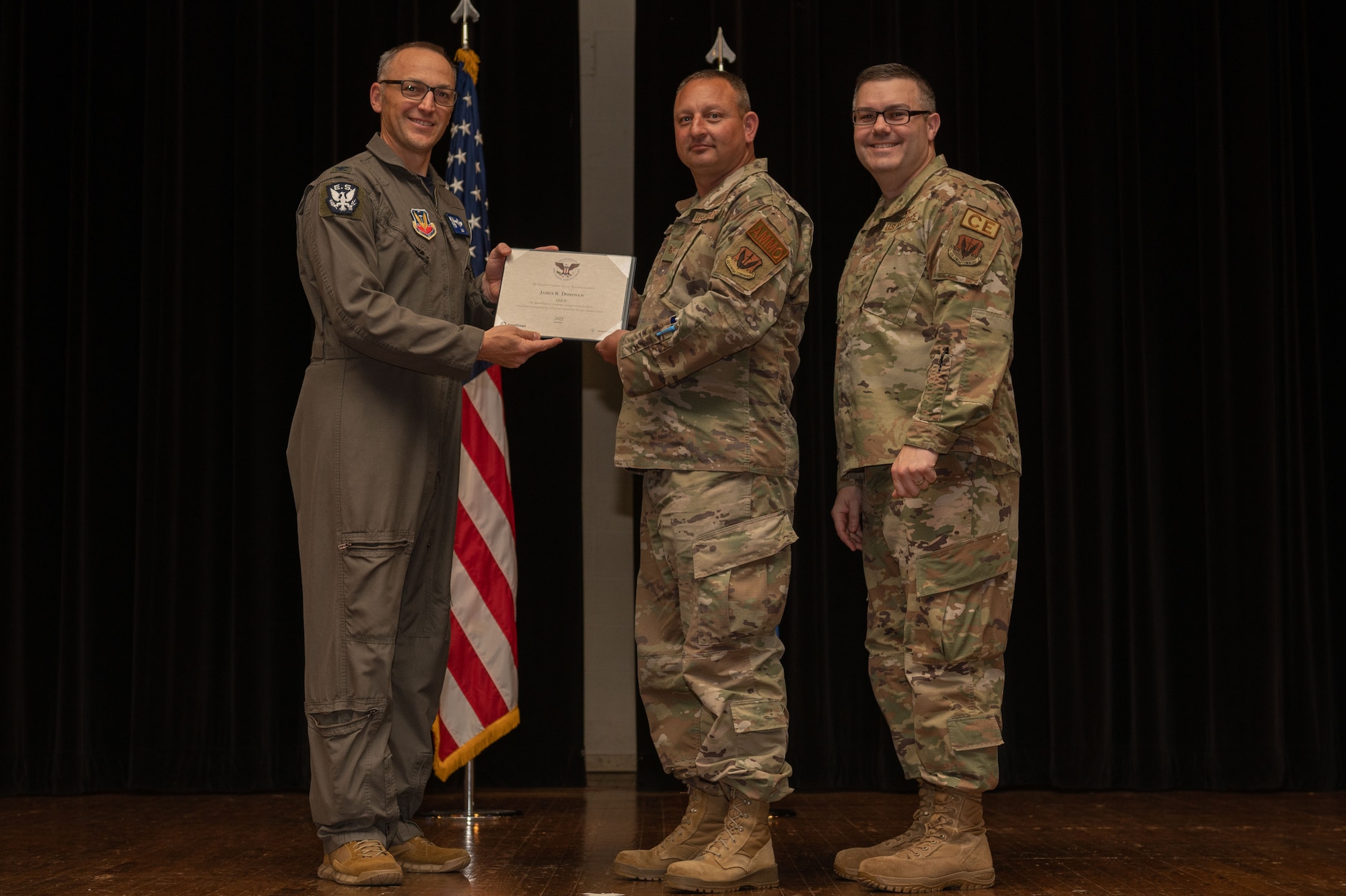 Col. Steven Bofferding, left, 4th Fighter Wing vice commander, and Chief Master Sgt. Kyle O’Hara, right, 4th Civil Engineer Squadron command chief, present the Gold Presidential Volunteer Service Award to a Seymour Johnson Air Force Base volunteer during a volunteer appreciation ceremony at Seymour Johnson Air Force Base, North Carolina, April 21, 2023. The Gold award winners have completed 250 or more hours for young adults, 500 or more hours for adults and 1000 or more hours for families and groups. (U.S. Air Force photo by Airman 1st Class Rebecca Sirimarco-Lang)