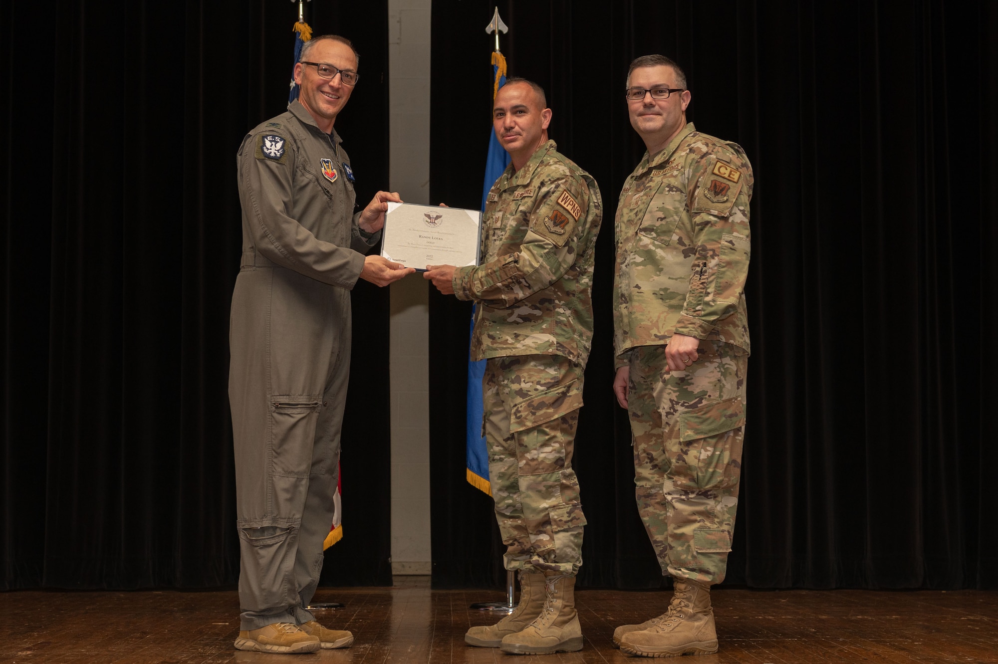 Col. Steven Bofferding, left, 4th Fighter Wing vice commander, and Chief Master Sgt. Kyle O’Hara, right, 4th Civil Engineer Squadron command chief, present the Gold Presidential Volunteer Service Award to a Seymour Johnson Air Force Base volunteer during a volunteer appreciation ceremony at Seymour Johnson Air Force Base, North Carolina, April 21, 2023. The Gold award winners have completed 250 or more hours for young adults, 500 or more hours for adults and 1000 or more hours for families and groups. (U.S. Air Force photo by Airman 1st Class Rebecca Sirimarco-Lang)