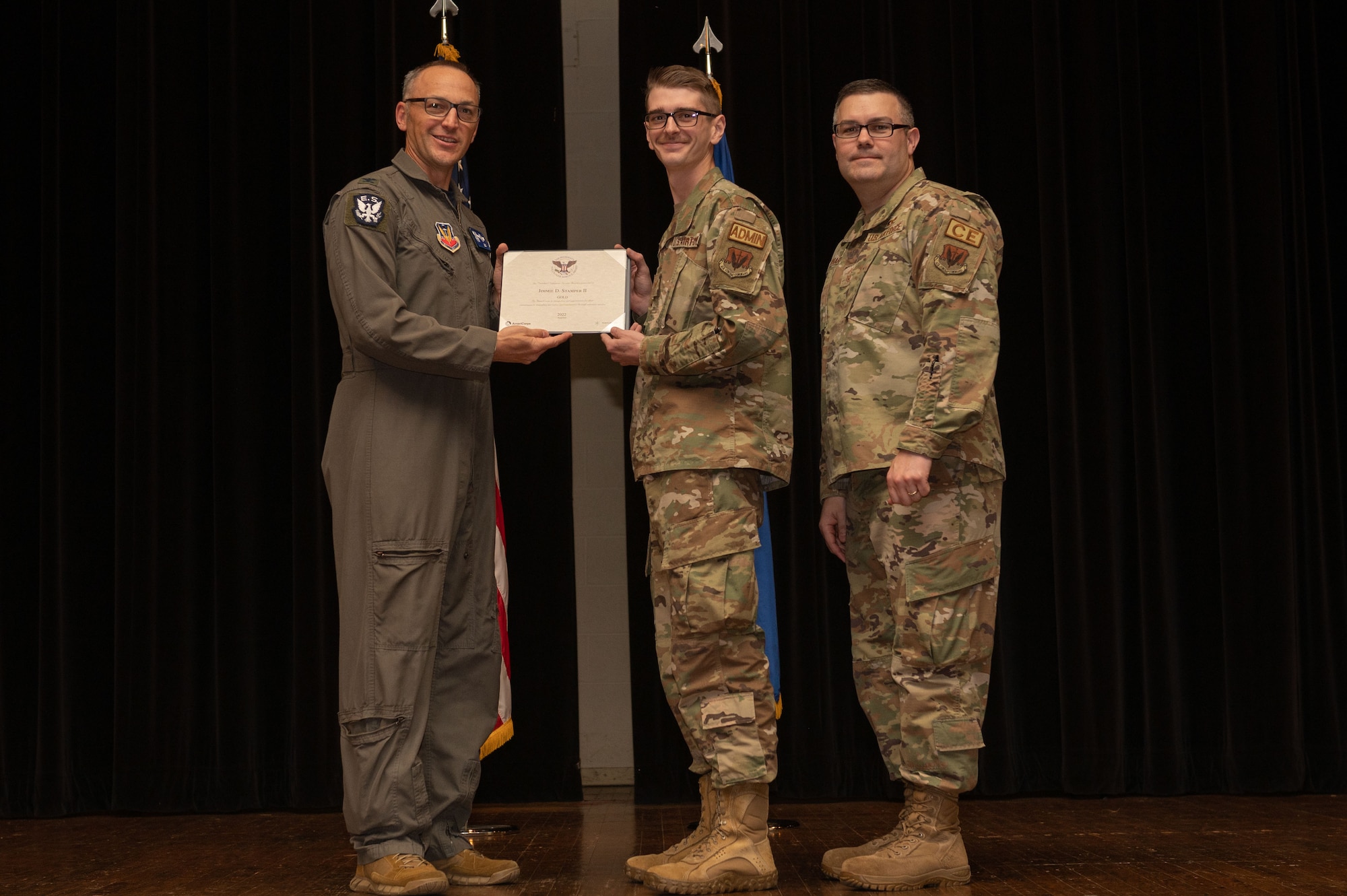 Col. Steven Bofferding, left, 4th Fighter Wing vice commander, and Chief Master Sgt. Kyle O’Hara, right, 4th Civil Engineer Squadron command chief, present the Gold Presidential Volunteer Service Award to a Seymour Johnson Air Force Base volunteer during a volunteer appreciation ceremony at Seymour Johnson Air Force Base, North Carolina, April 21, 2023. The Gold award winners have completed 250 or more hours for young adults, 500 or more hours for adults and 1000 or more hours for families and groups. (U.S. Air Force photo by Airman 1st Class Rebecca Sirimarco-Lang)