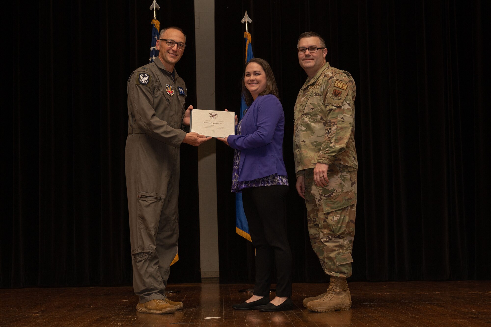 Col. Steven Bofferding, left, 4th Fighter Wing vice commander, and Chief Master Sgt. Kyle O’Hara, right, 4th Civil Engineer Squadron command chief, present the Gold Presidential Volunteer Service Award to a Seymour Johnson Air Force Base volunteer during a volunteer appreciation ceremony at Seymour Johnson Air Force Base, North Carolina, April 21, 2023. The Gold award winners have completed 250 or more hours for young adults, 500 or more hours for adults and 1000 or more hours for families and groups. (U.S. Air Force photo by Airman 1st Class Rebecca Sirimarco-Lang)