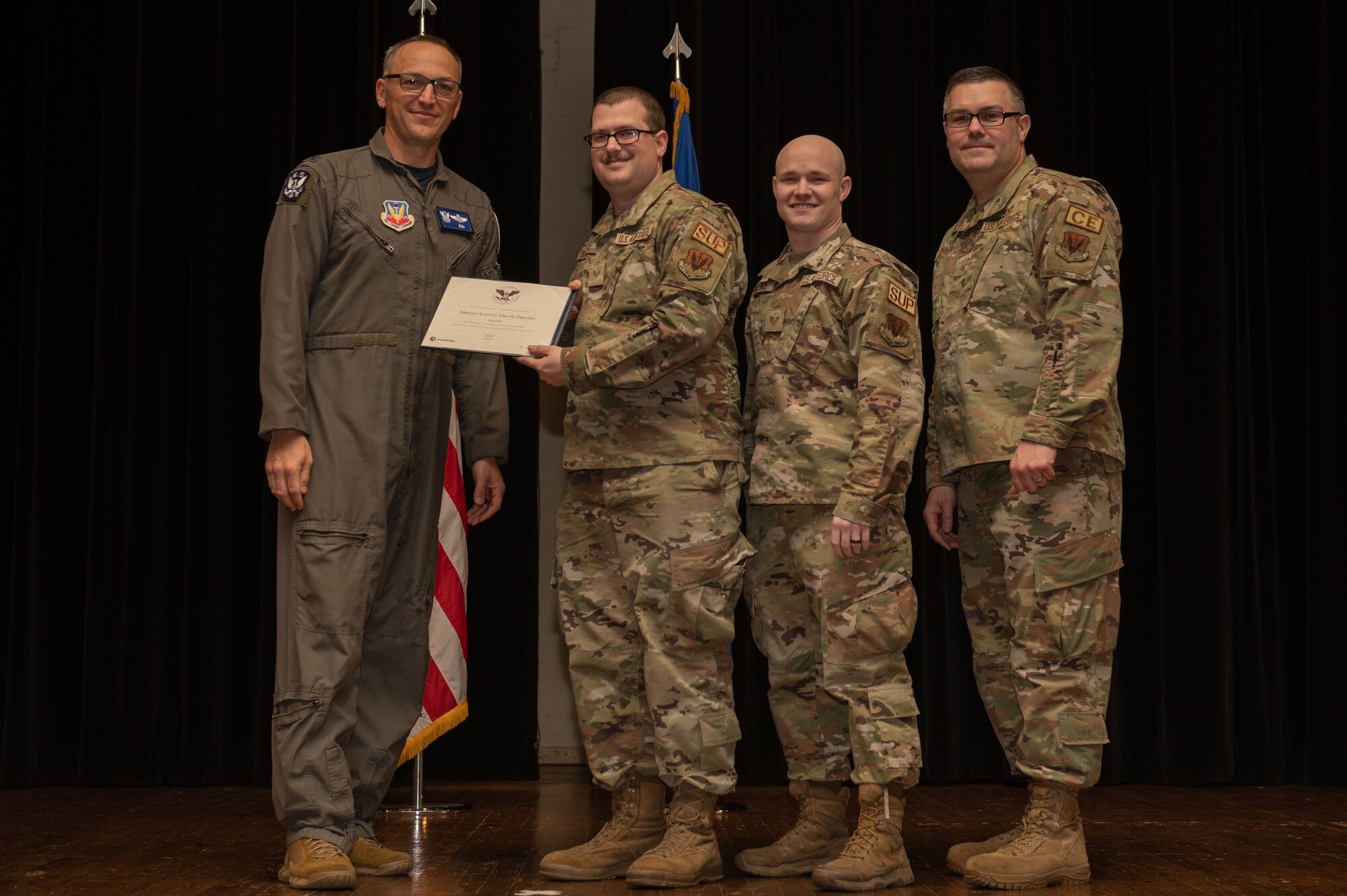 Col. Steven Bofferding, left, 4th Fighter Wing vice commander, and Chief Master Sgt. Kyle O’Hara, right, 4th Civil Engineer Squadron command chief, present the Sliver Presidential Volunteer Service Award to a Seymour Johnson Air Force Base volunteers during a volunteer appreciation ceremony at Seymour Johnson Air Force Base, North Carolina, April 21, 2023. The Sliver award winners have completed 175 to 249 hours for young adults, 250 to 499 hours for adults and 500 to 999 for families and groups. (U.S. Air Force photo by Airman 1st Class Rebecca Sirimarco-Lang)