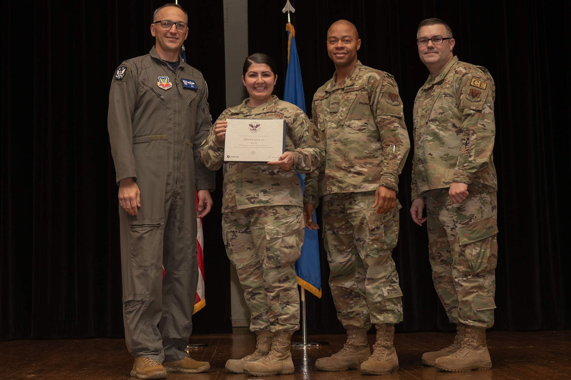 Col. Steven Bofferding, left, 4th Fighter Wing vice commander, and Chief Master Sgt. Kyle O’Hara, right, 4th Civil Engineer Squadron command chief, present the Sliver Presidential Volunteer Service Award to a Seymour Johnson Air Force Base volunteers during a volunteer appreciation ceremony at Seymour Johnson Air Force Base, North Carolina, April 21, 2023. The Sliver award winners have completed 175 to 249 hours for young adults, 250 to 499 hours for adults and 500 to 999 for families and groups. (U.S. Air Force photo by Airman 1st Class Rebecca Sirimarco-Lang)