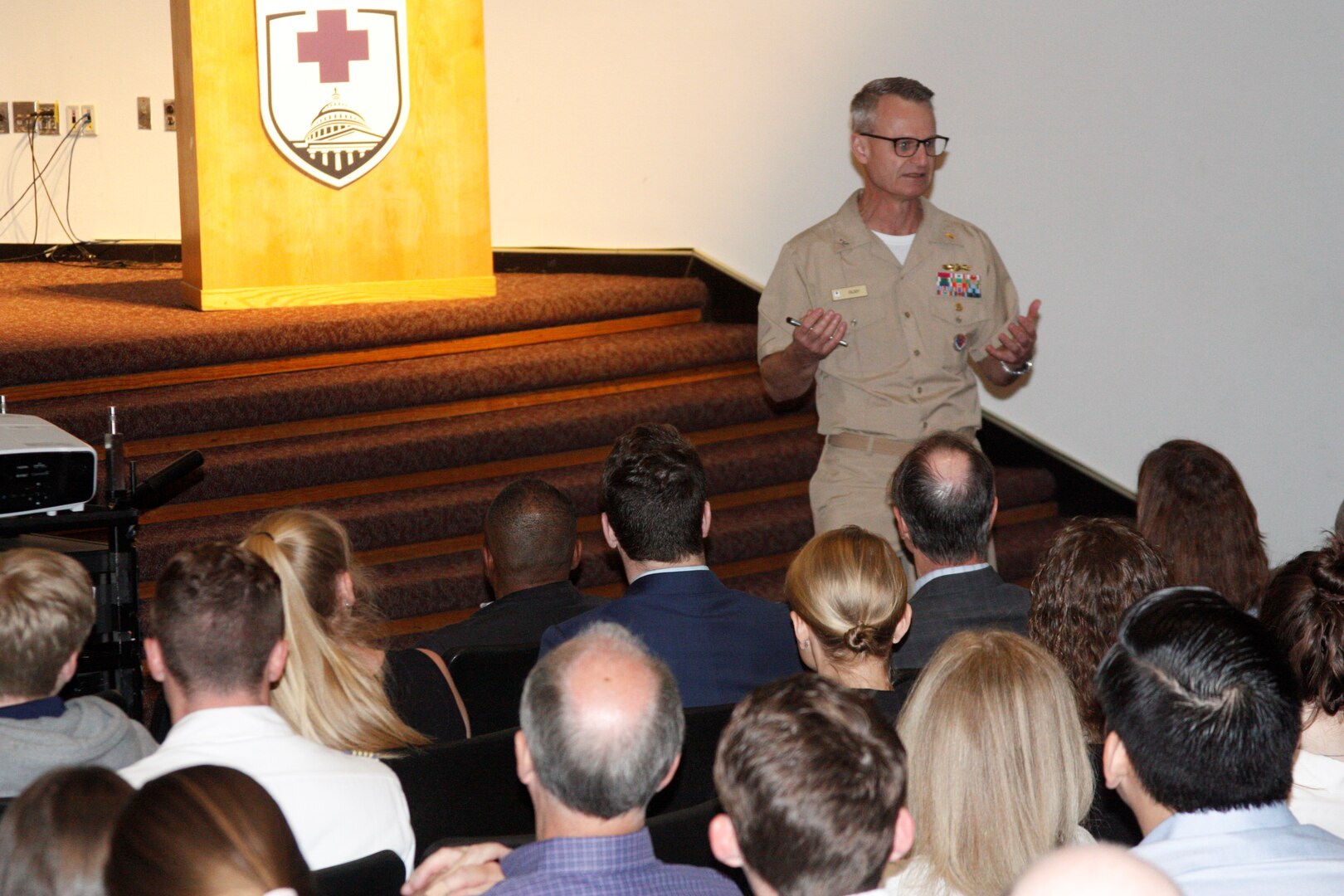 Group photo with Capt. Bigby speaking to prospective students.