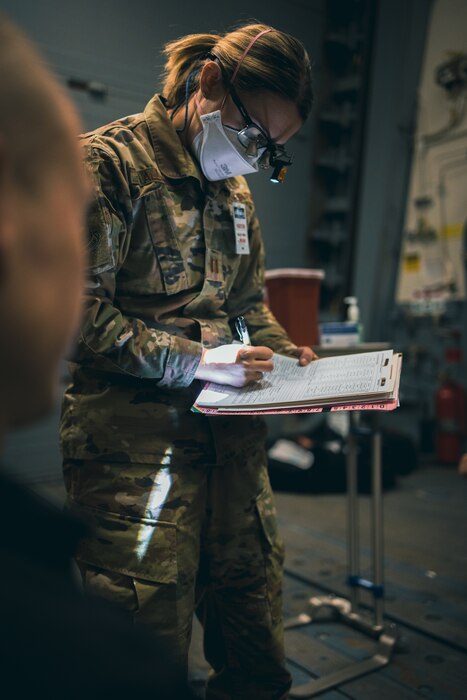 Captain Katelyn Allen reviews dental records for her patient on board the USS Carl M. Levin. A team of Airmen from the 101st Air Refueling Wing traveled to the destroyer located at Bath Iron Works on April 20, 2023 to assist in prepping the crew for the ships maiden voyage.