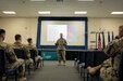 U.S. Air National Guard Col. Deane E. Thomey, Commander 111th Attack Wing, addresses members of the 111th ATKW during Sexual Assault Awareness and Prevention Month (SAAPM) prior to a training session designed to demonstrate effective tactics to combat and prevent sexual assault at Biddle Air National Guard Base in Horsham, Pennsylvania, April 2, 2023. Vivian Claud, 111th ATKW Sexual Assault Response Coordinator, and her team of volunteer victim advocates, organized events during April’s regularly schedule drill to educate the Wing about the Sexual Assault Prevention and Response program, as well as provide resources available for sexual assault survivors. (U.S. Air National Guard courtesy photo by Matthew Bergh)