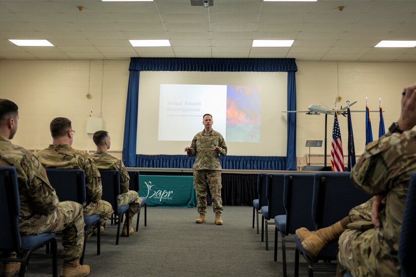 U.S. Air National Guard Col. Deane E. Thomey, Commander 111th Attack Wing, addresses members of the 111th ATKW during Sexual Assault Awareness and Prevention Month (SAAPM) prior to a training session designed to demonstrate effective tactics to combat and prevent sexual assault at Biddle Air National Guard Base in Horsham, Pennsylvania, April 2, 2023. Vivian Claud, 111th ATKW Sexual Assault Response Coordinator, and her team of volunteer victim advocates, organized events during April’s regularly schedule drill to educate the Wing about the Sexual Assault Prevention and Response program, as well as provide resources available for sexual assault survivors. (U.S. Air National Guard courtesy photo by Matthew Bergh)
