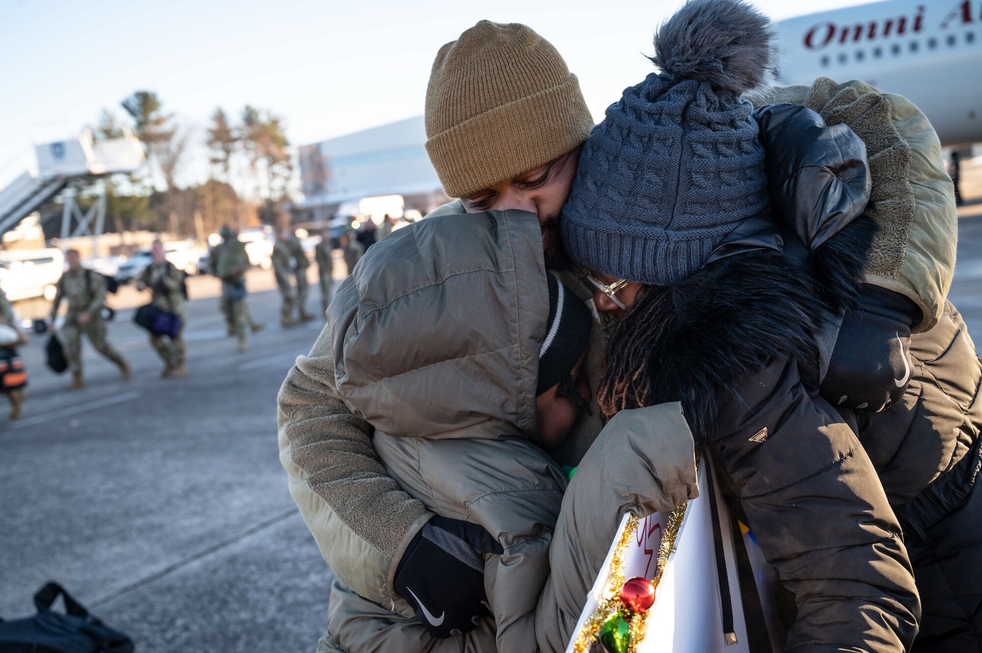 Master Sgt. Donavan Copeland, member of the 103rd Airlift Wing, Connecticut Air National Guard, embraces his family upon returning to Connecticut, December 13, 2022 at Bradley Air National Guard Base, Conn. Copeland served under the U.S. Africa Command during his deployment. (U.S. Air National Guard photo by Master Sgt. Tamara R. Dabney)