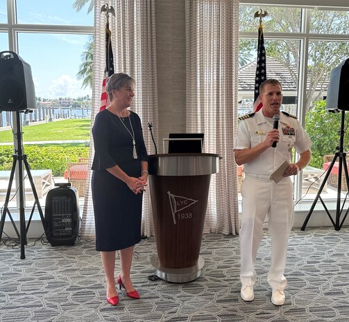 230426-N-ZK609-0007 Fort Lauderdale, Fla. (April 26, 2023). Alex Anagnostis-Irons, Co-Chair of Broward Navy Days watches Captain Greg Smith, Chief of Staff, Commander, Navy Region Southeast give the welcome at the Salute to Women in the Military Luncheon. This luncheon is annual event during Fleet Week Port Everglades (Photo by Navy Region Southeast Public Affairs Specialist Twilla Burns/released).
